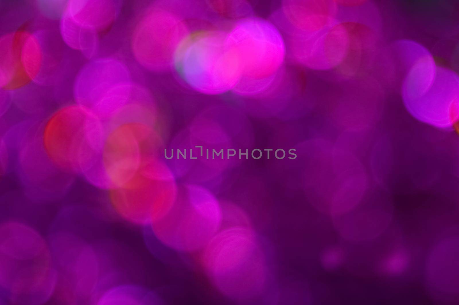 Colorful pink and purple bokeh defocused blurred lights and sparkles abstract background