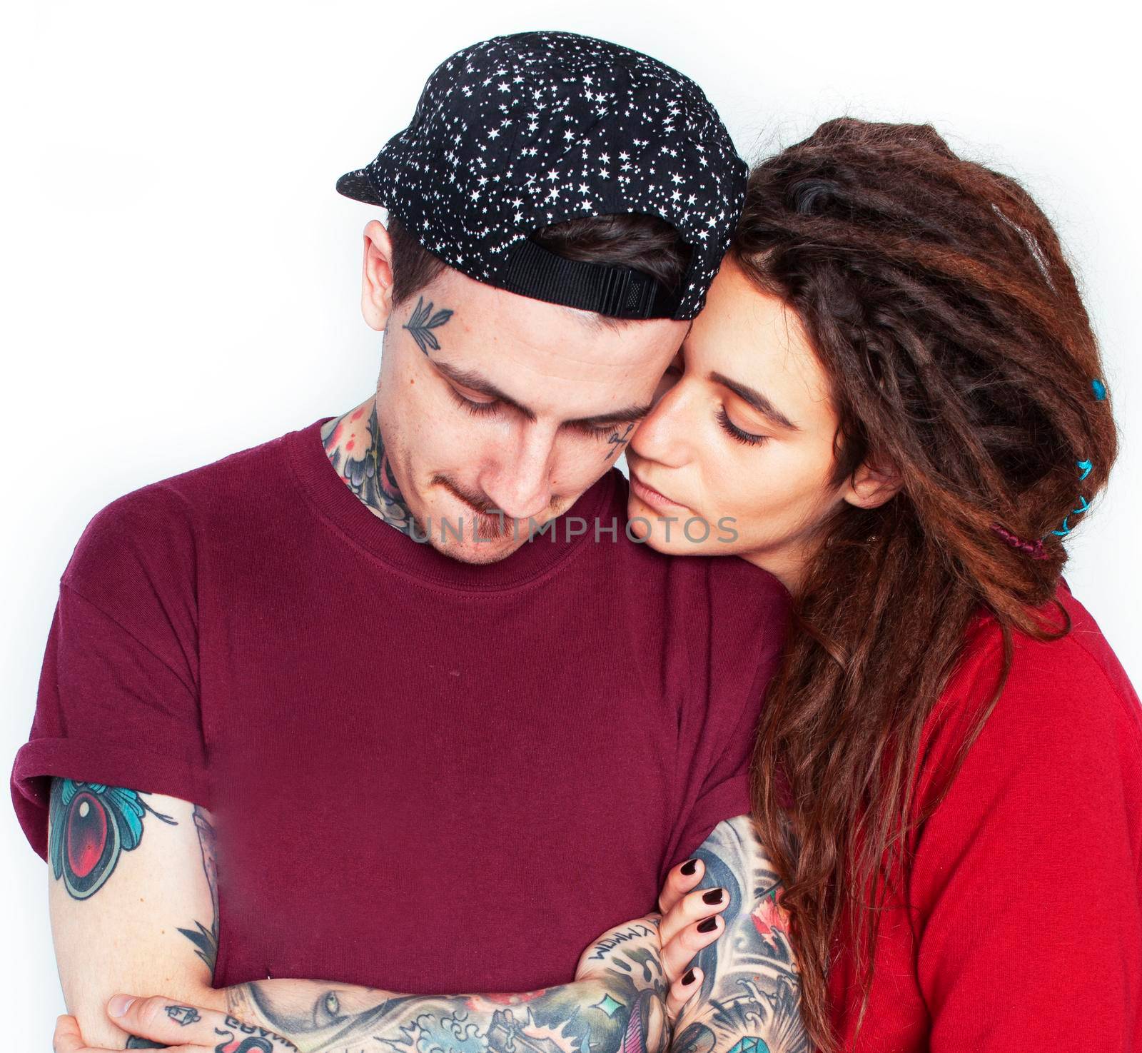 Young couple together. guy with tattoo, girlfriend wearing dreadlocks having fun on white background by JordanJ