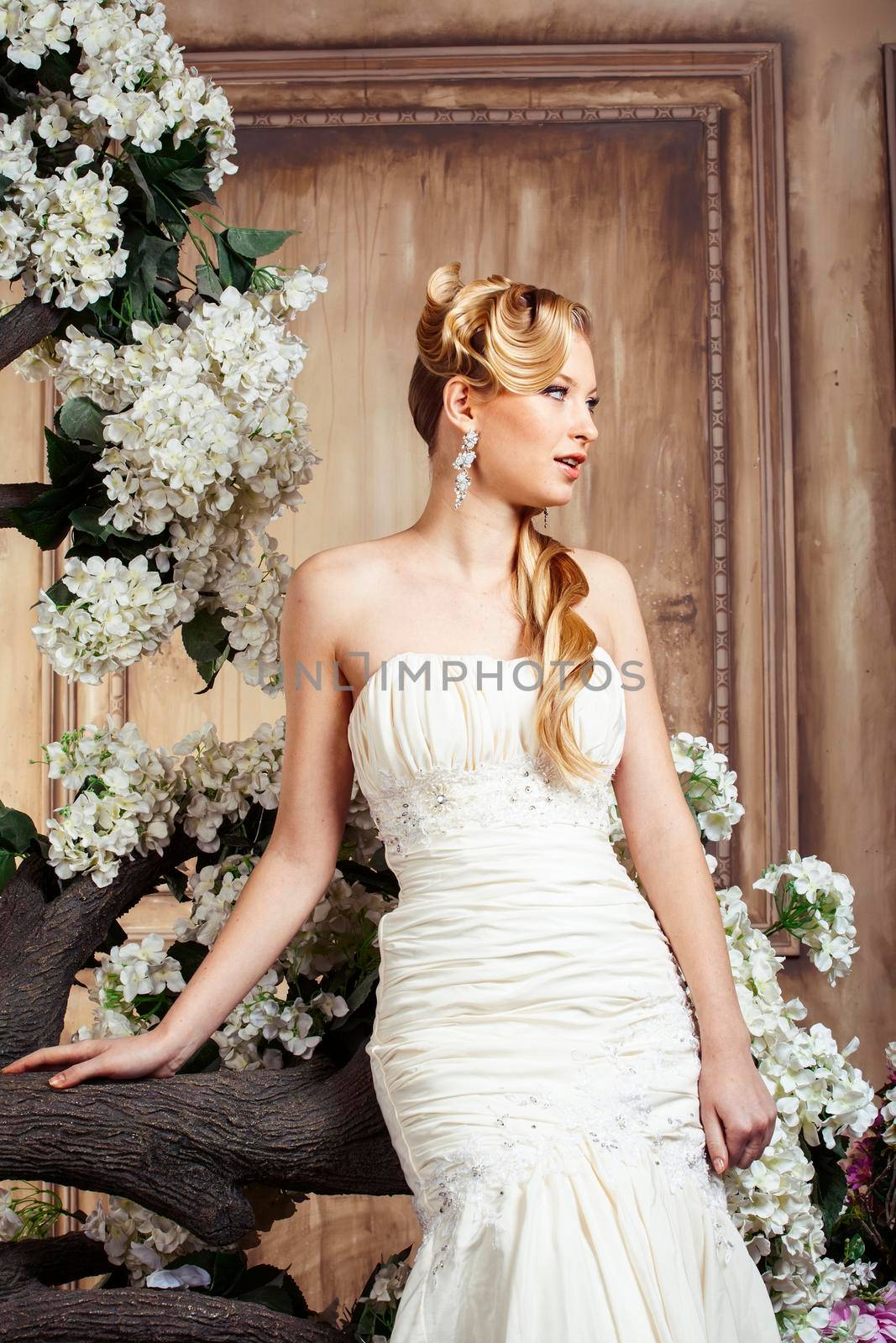 beauty young bride alone in luxury vintage interior with a lot of flowers, makeup and creative hairstyle by JordanJ