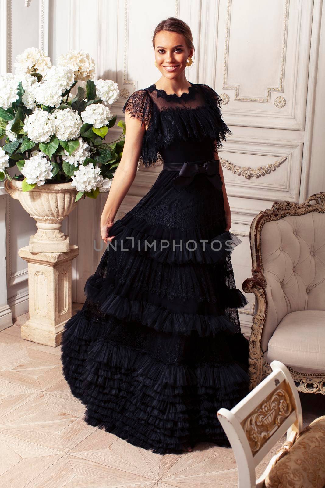 young pretty lady in black lace fashion style dress posing in rich interior of royal hotel room, luxury lifestyle people concept close up