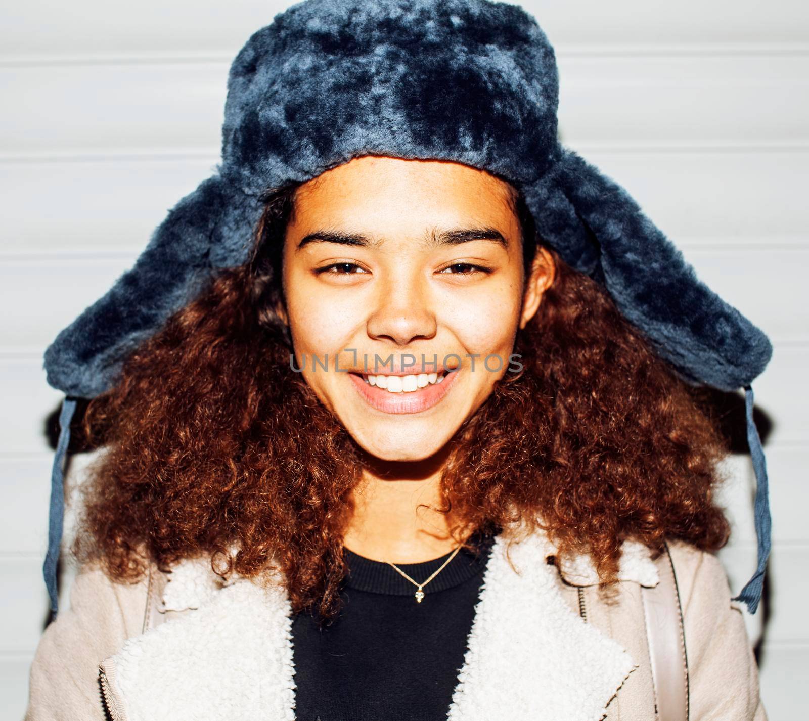 young pretty african american girl teenage outside on street, looking like real junky, social issues concept, red eyes, bum stupid hat, fashion hipster lifestyle people by JordanJ