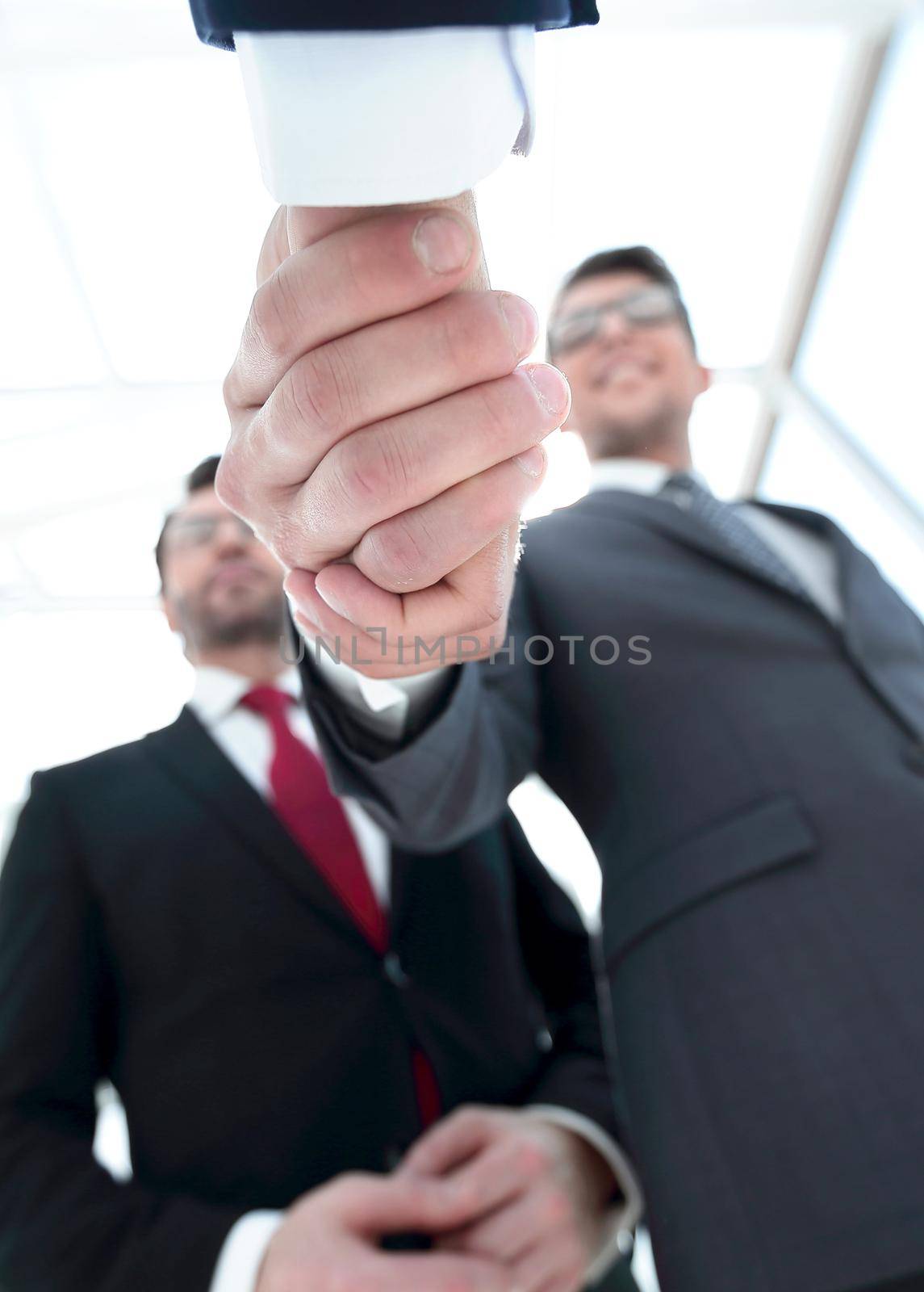 business background.handshake business people.close up