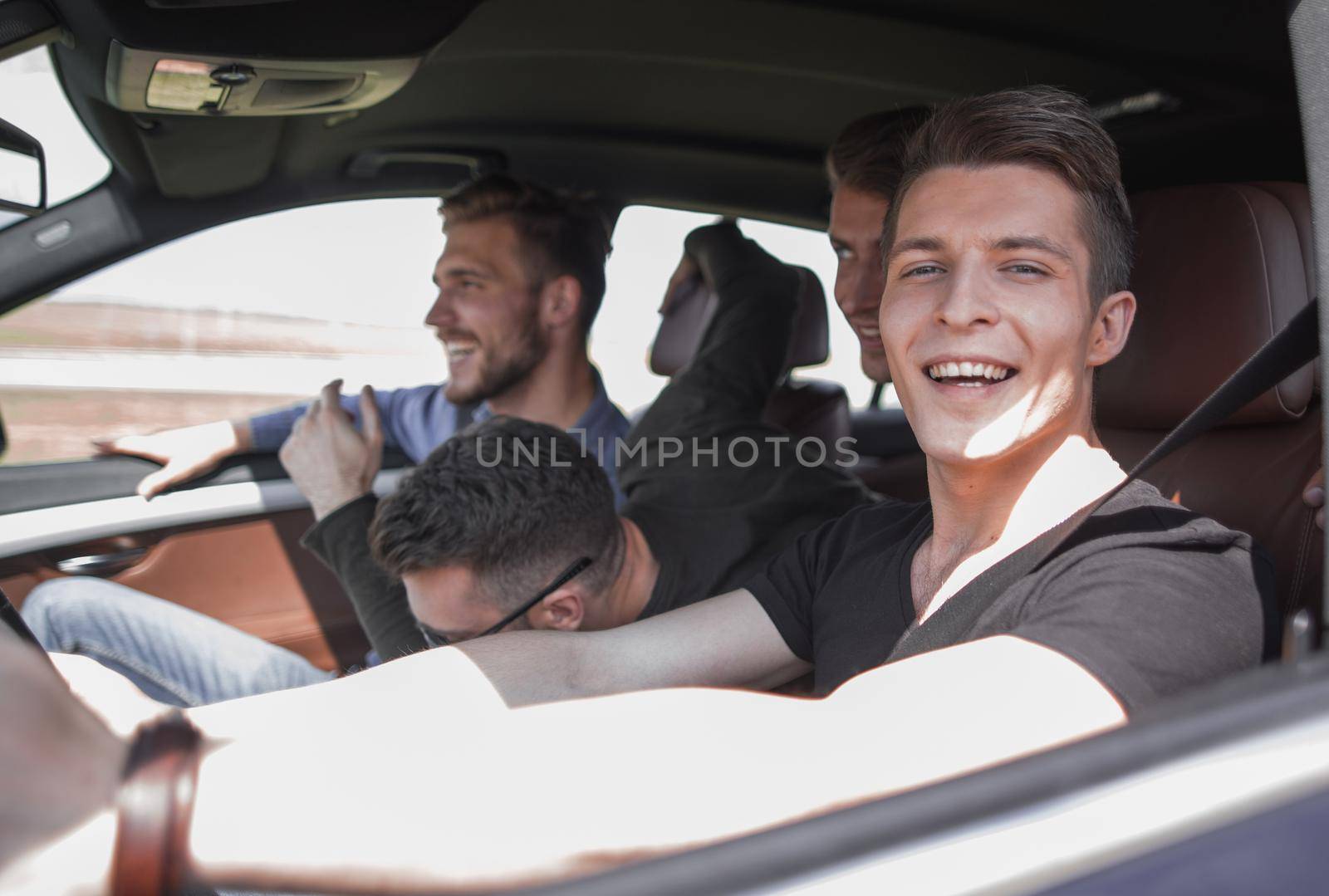 a group of boys rides and looks directly at the car by asdf
