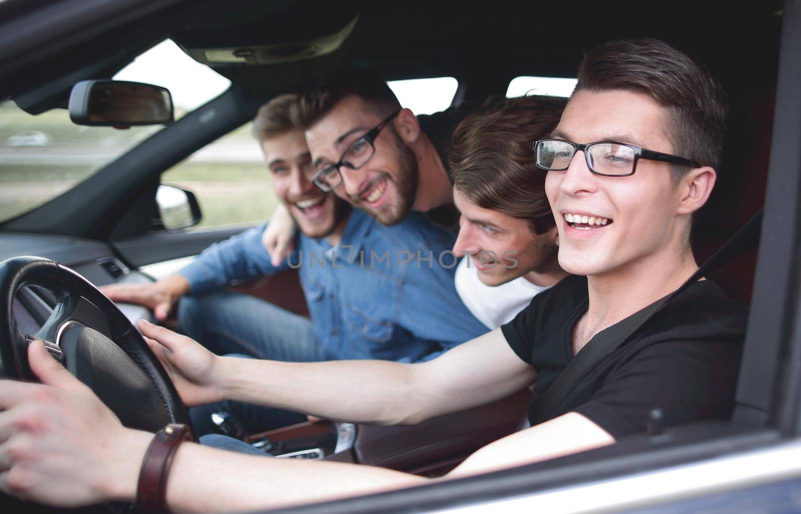 A young man rides in a car at high speed by asdf