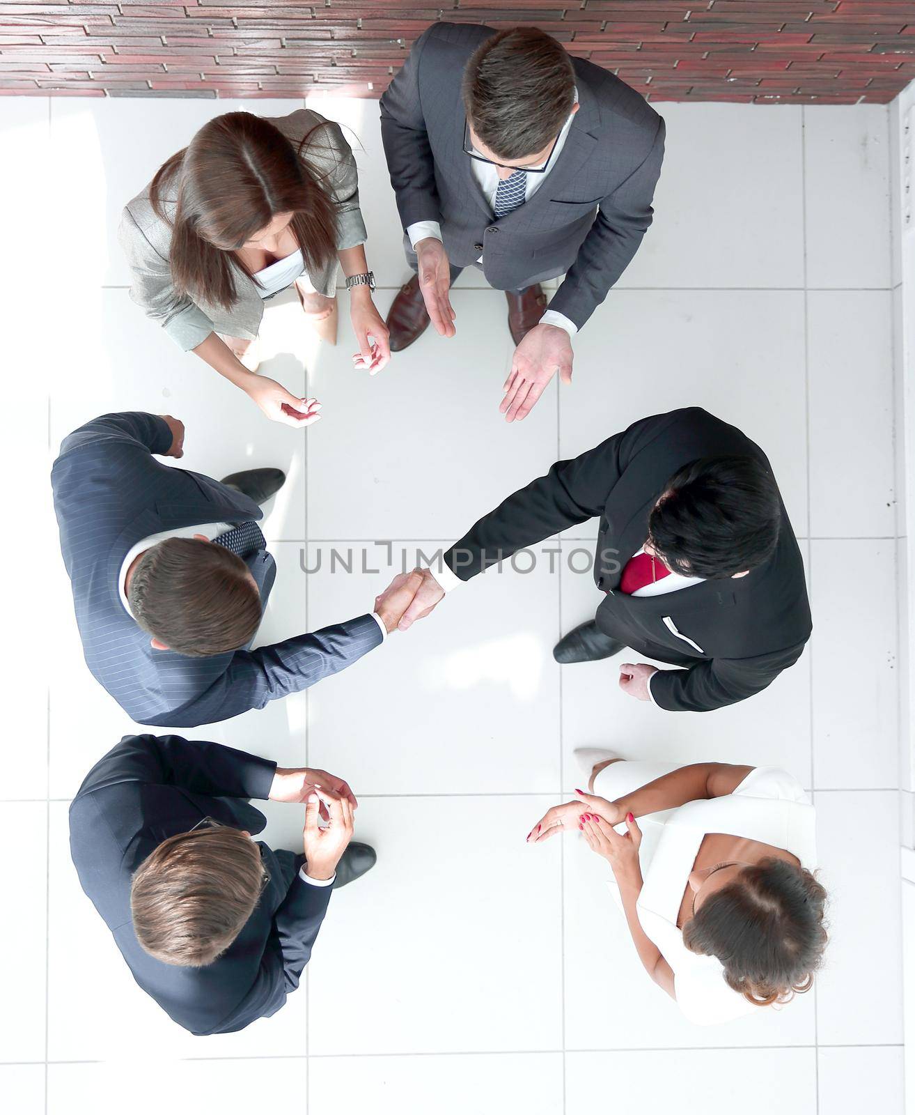 top view.business partners shaking hands by asdf