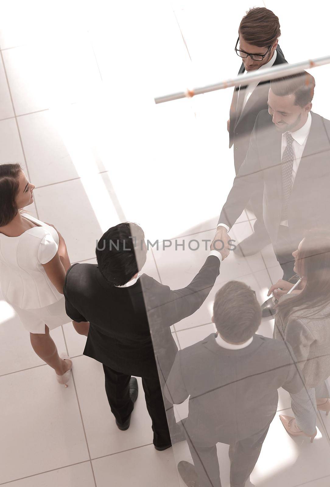 business background.handshake business men in the circle of employees. business concept