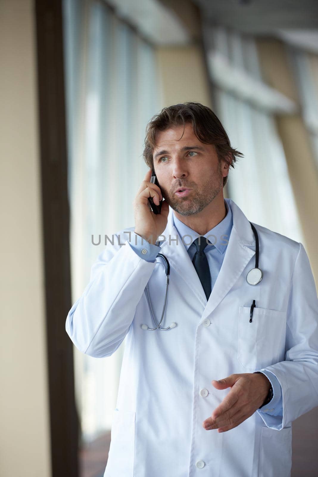 doctor speaking on cellphone by dotshock