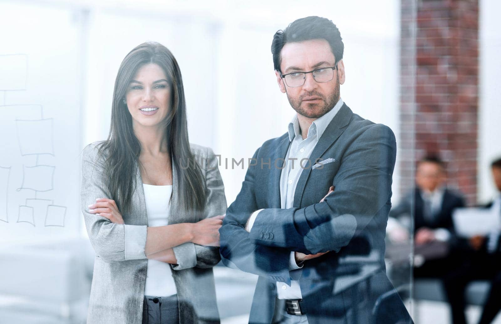 businessman and businesswoman look through the window of a modern office by asdf