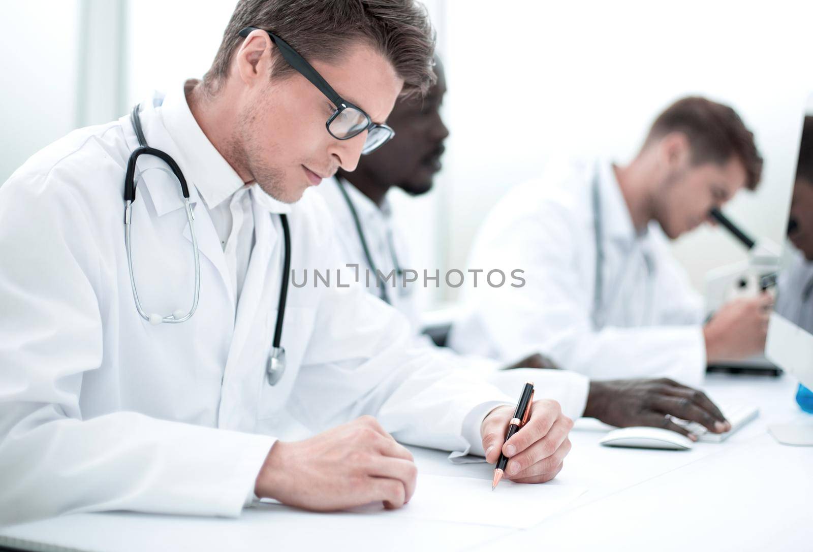 experienced doctor sitting at the laboratory table by asdf