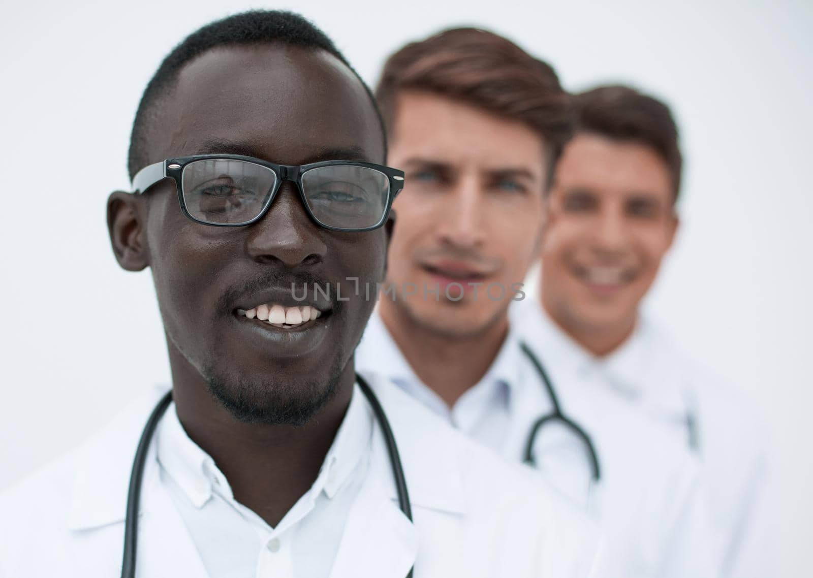 group of multi-racial doctors standing in a row by asdf