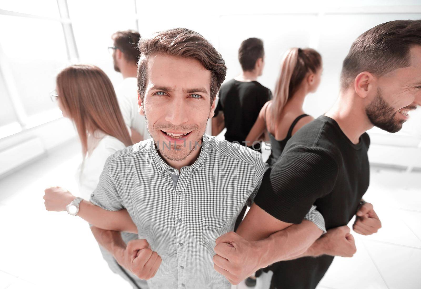 young people, with their hands together in a circle.the concept of team building