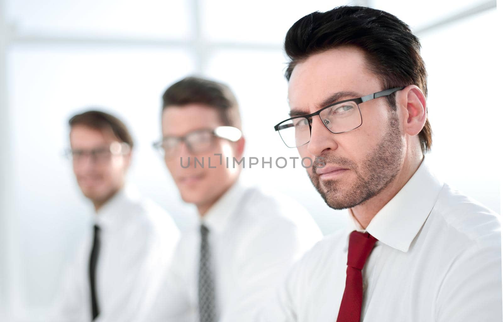 close up.confident businessman on background of colleagues.business background