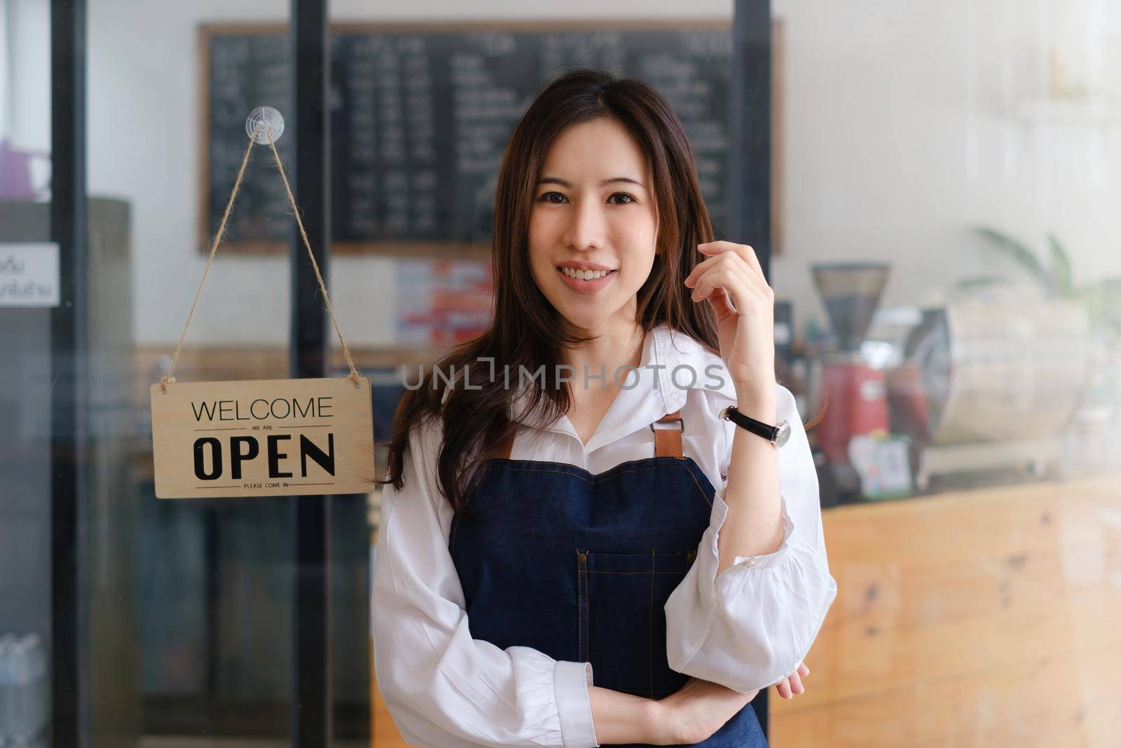 Asian coffee shop owner in coffee shop. Small business owner and startup in coffee shop concept. by itchaznong