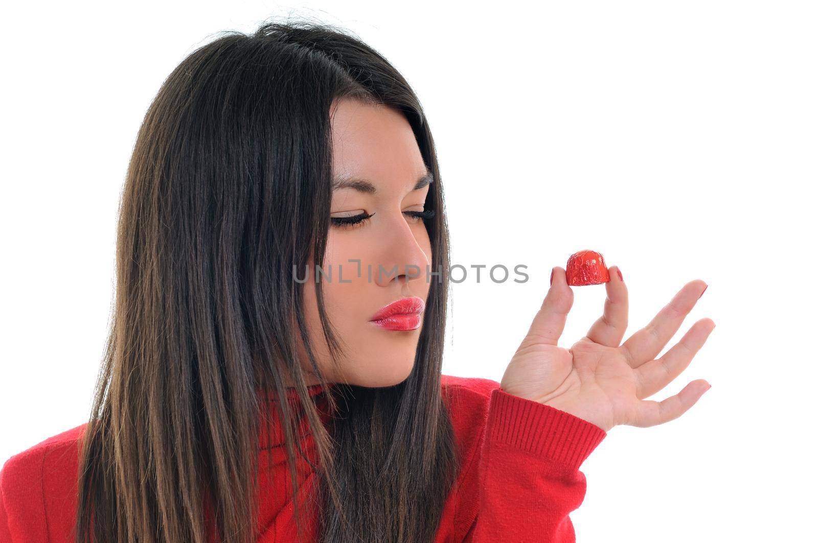 young woman isolated on white in red shirt eat sweet tasty chocolate