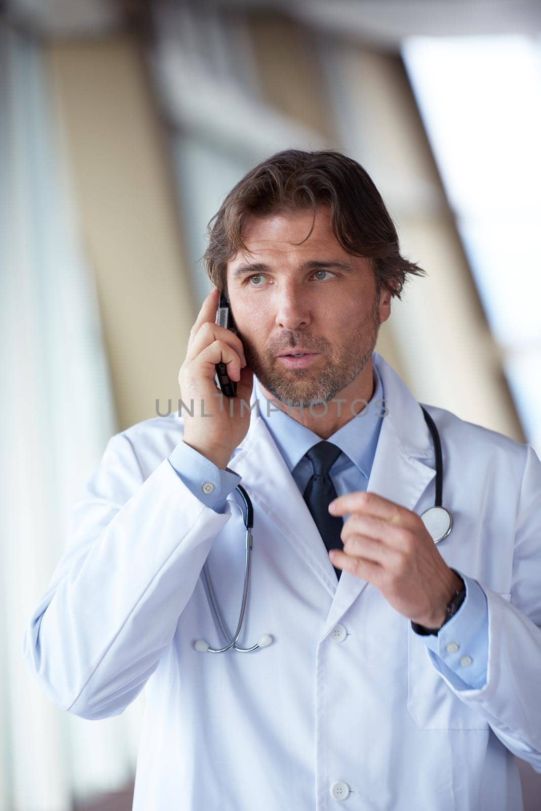doctor speaking on cellphone by dotshock