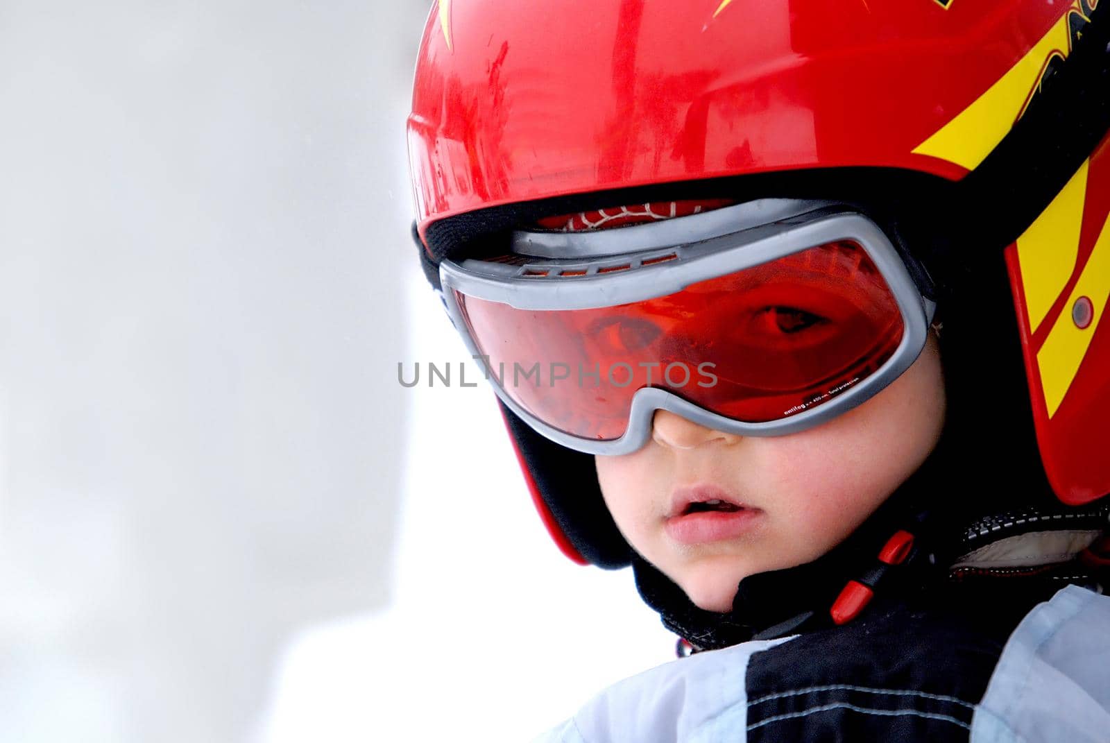 Little skier with helmet and goggles by dotshock