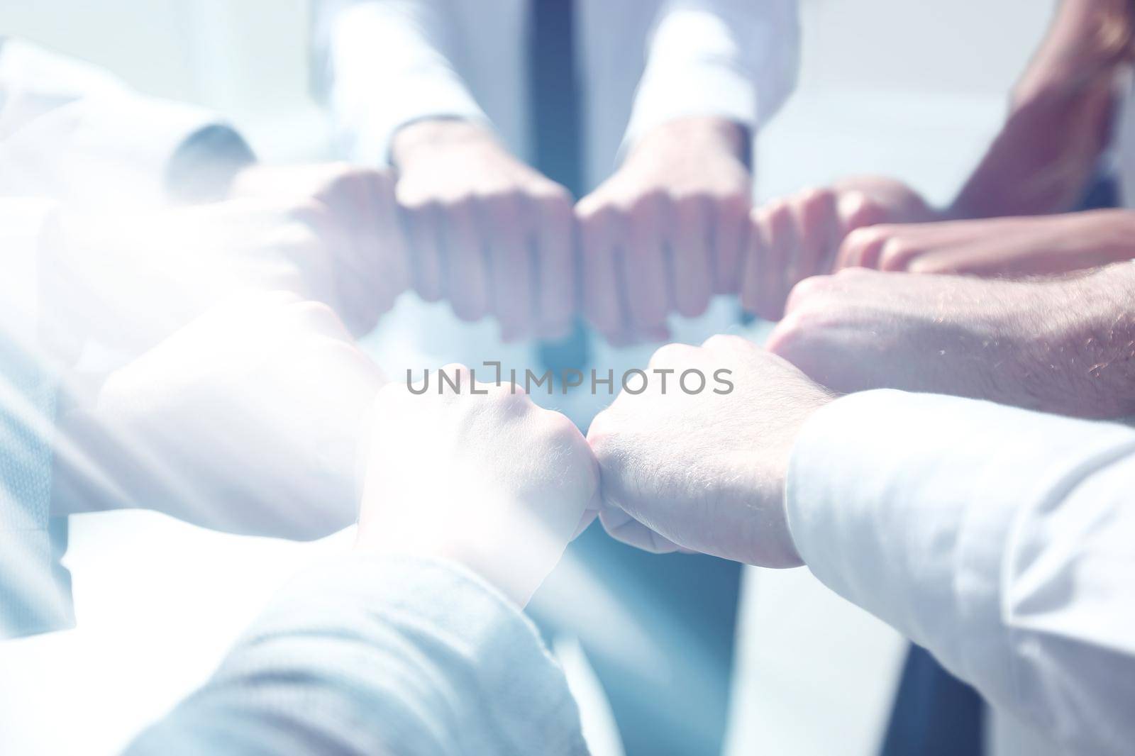 close up. business team forming a circle, out of their fists by asdf