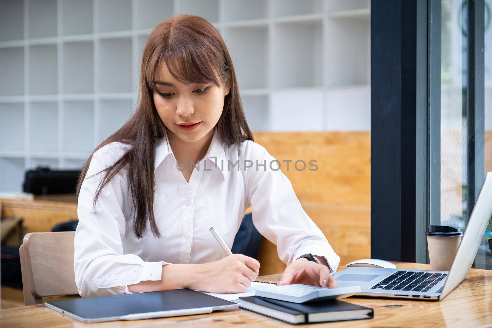 Cheerful young asian woman using laptop computer at home. Student female in living room. online learning, studying , online shopping, freelance, asean concept. by itchaznong