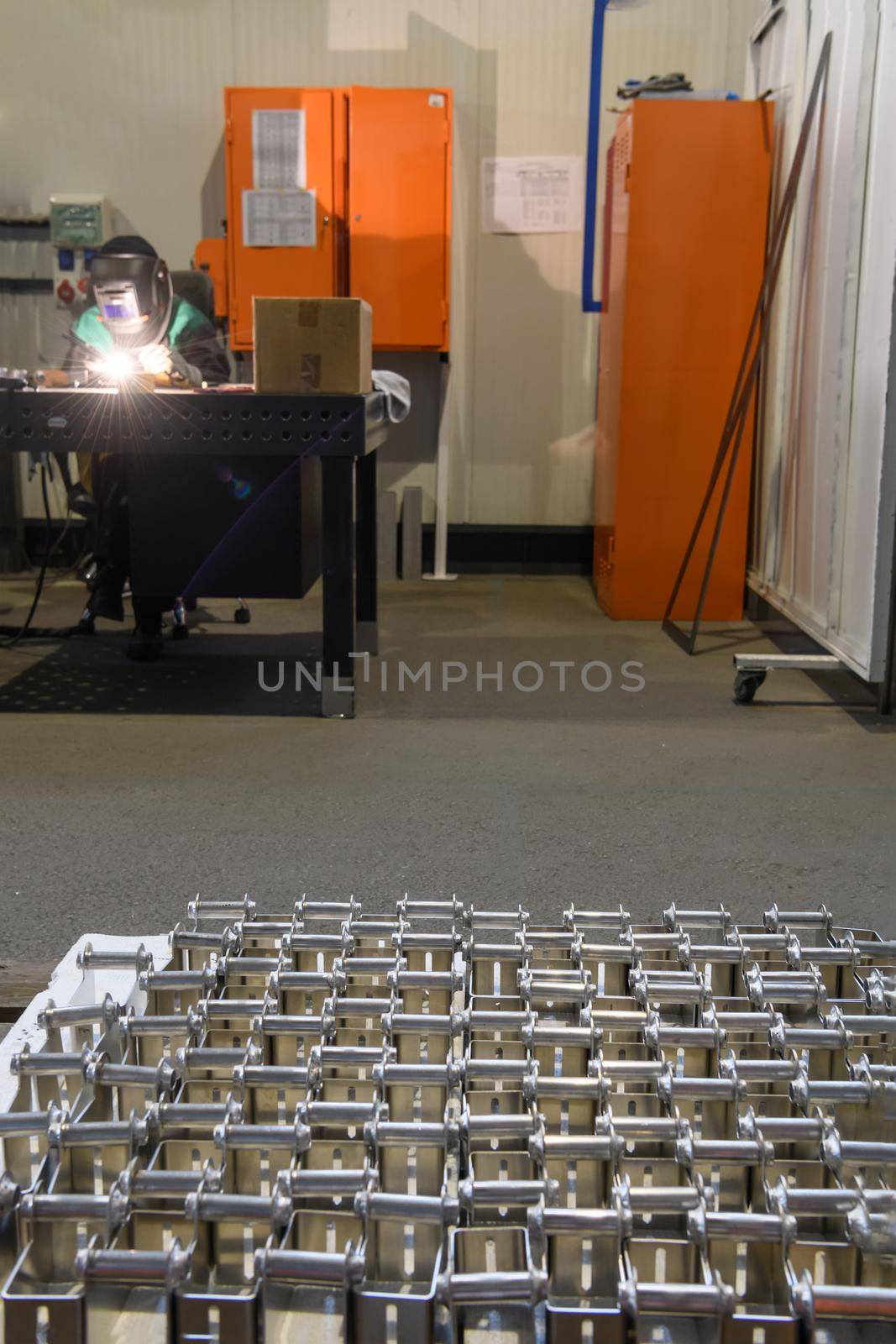 The first phase of metal and aluminum processing. Processed products from CNC machines stacked on a pallet in a large modern factory. High quality photo