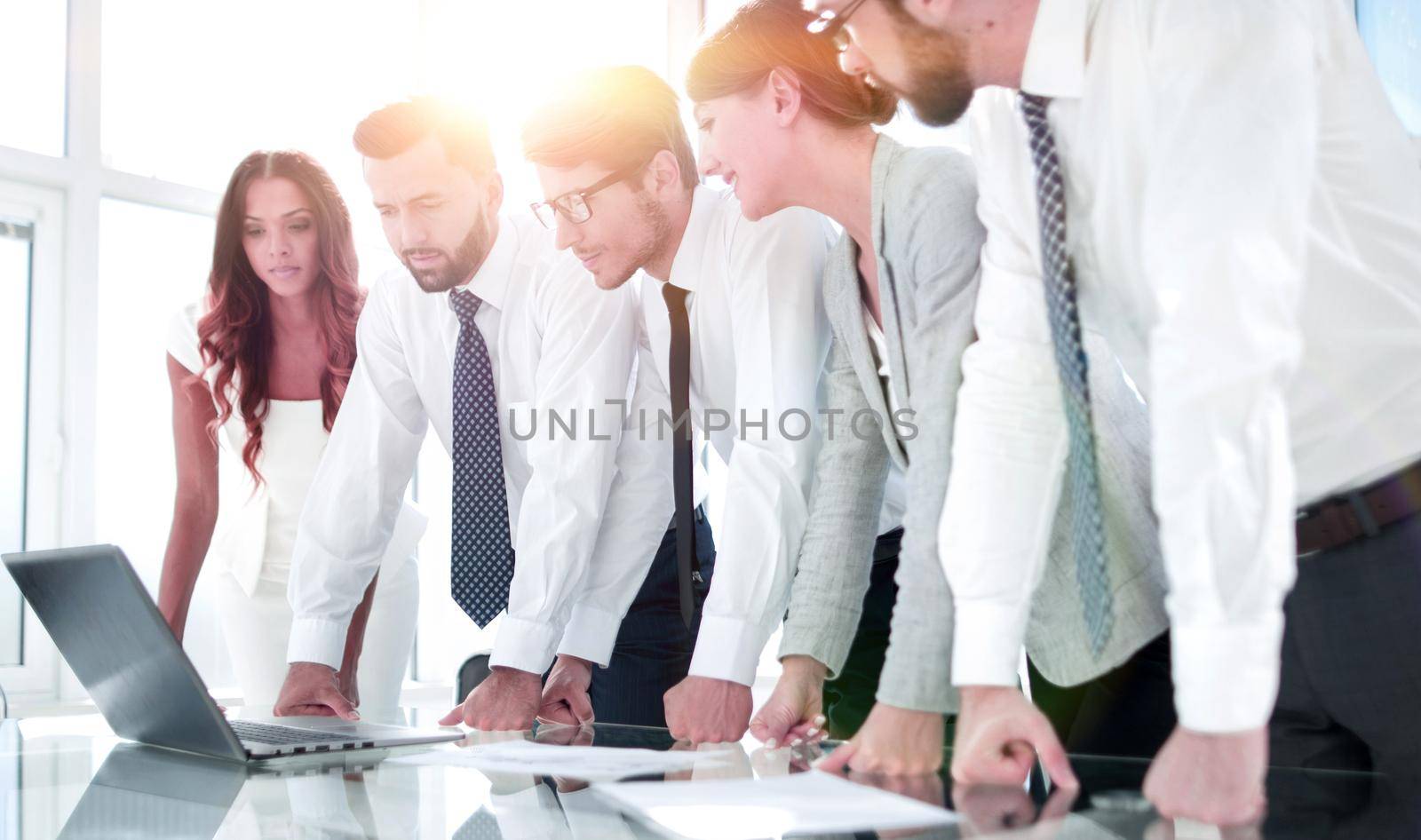 employees look closely at the laptop screen.people and technology