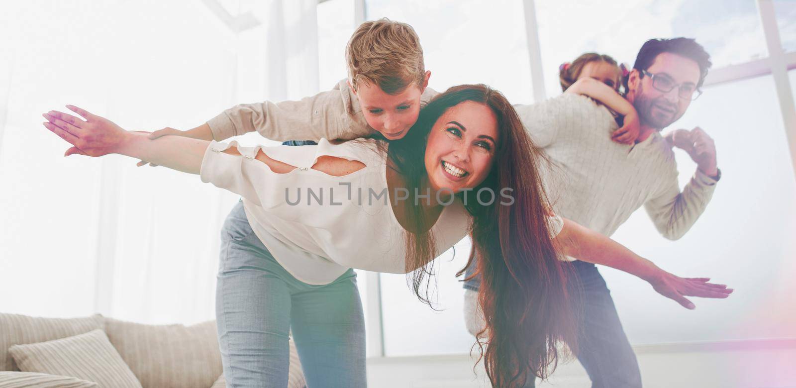 happy parents play with their children in the spacious living room.photo with copy space