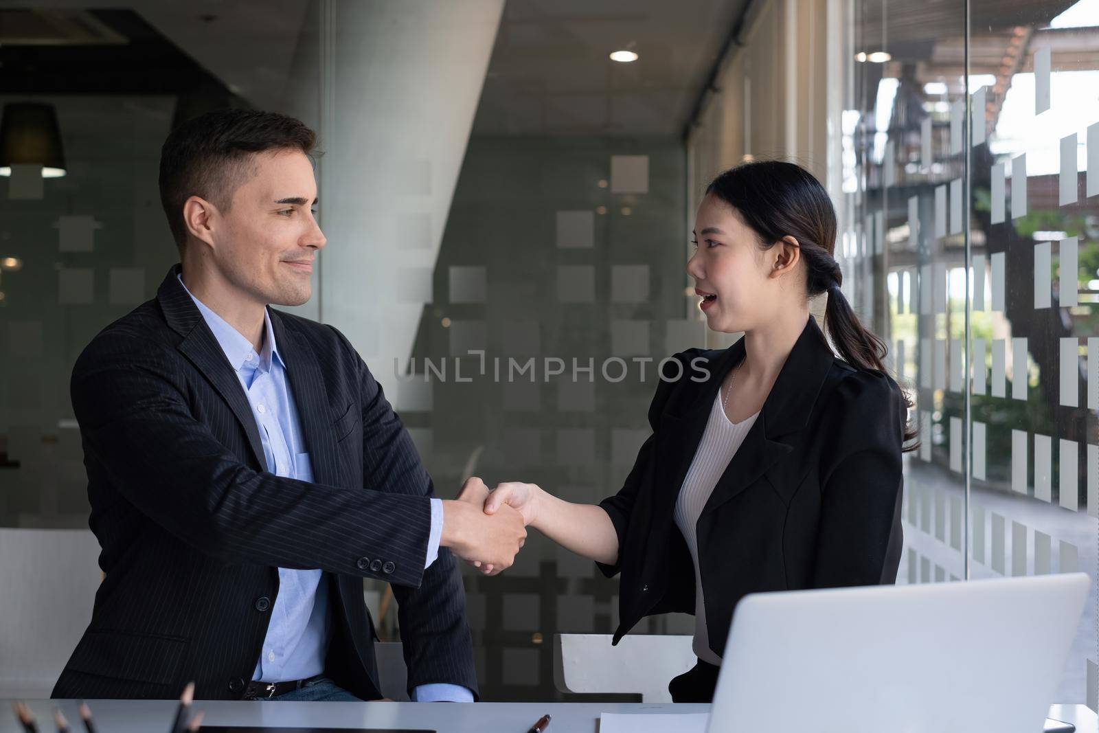 Businessman and partner handshake for the new agreement after sign in agreement contract with work together. by itchaznong