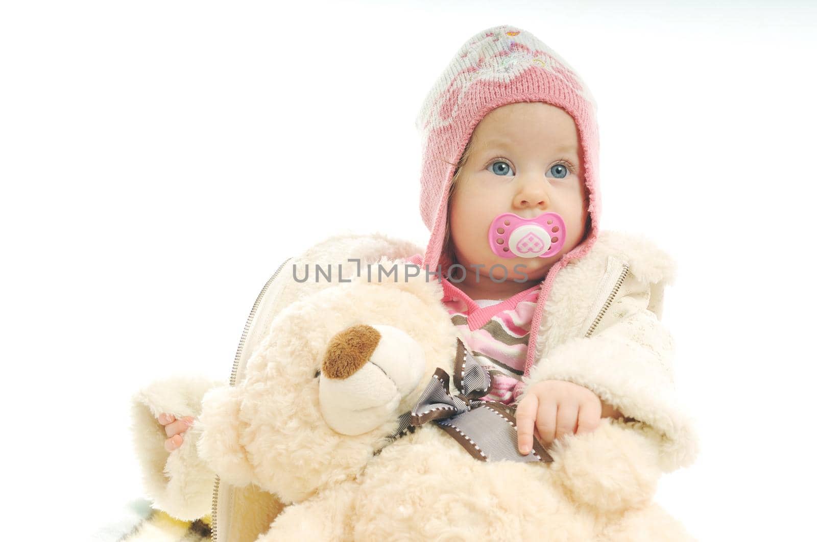 cute happy little baby with winter hat and coat isolated on white