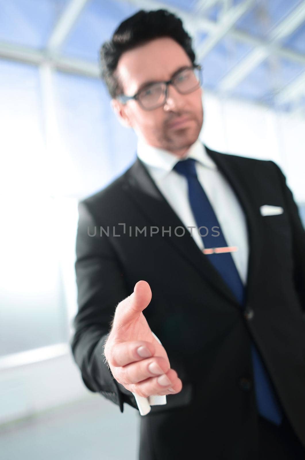 businessman holding out his hand for a handshake.concept of partnership