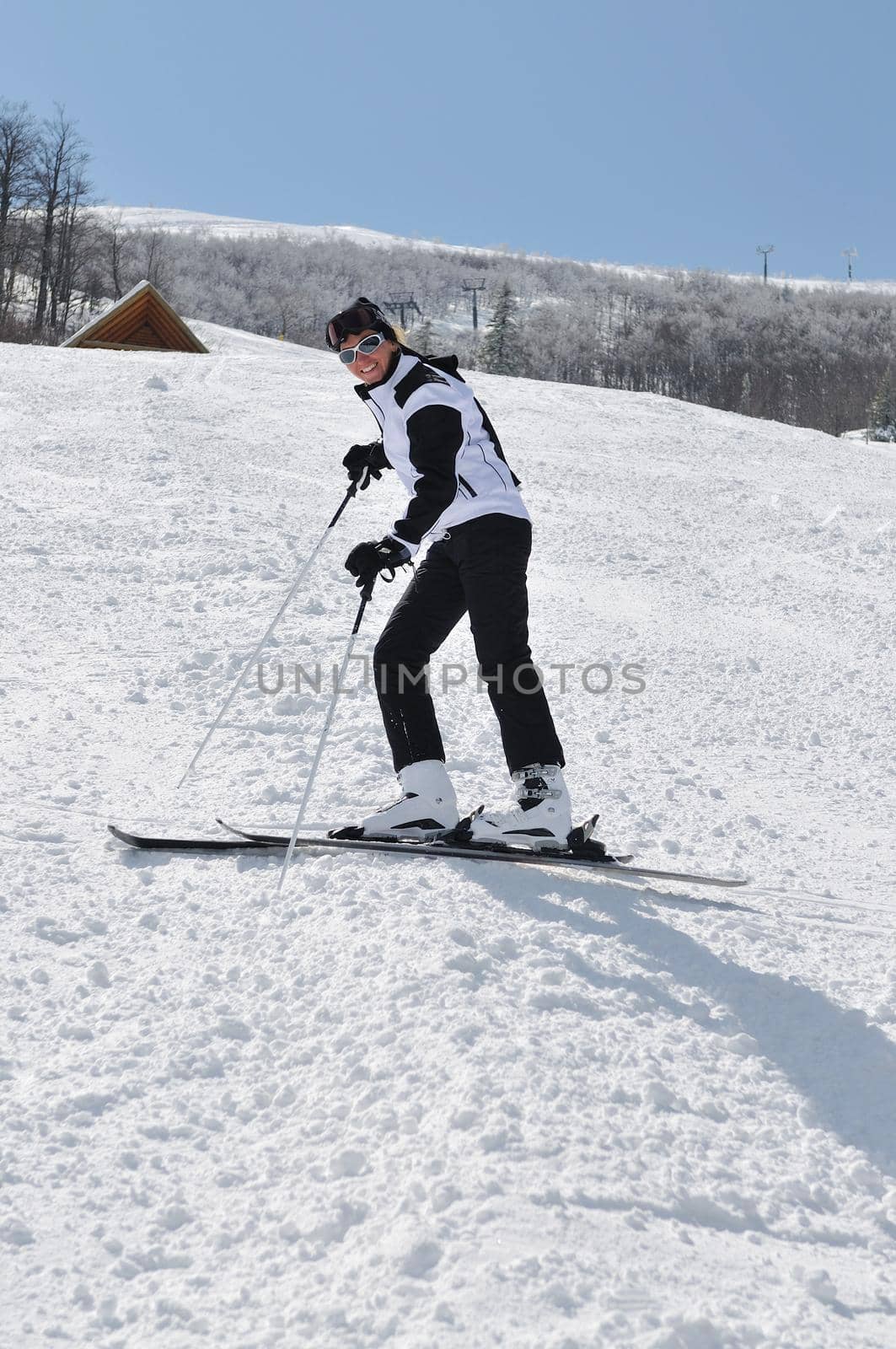 happy skier woman portrait on slopes at winter season and beautiful sunny day