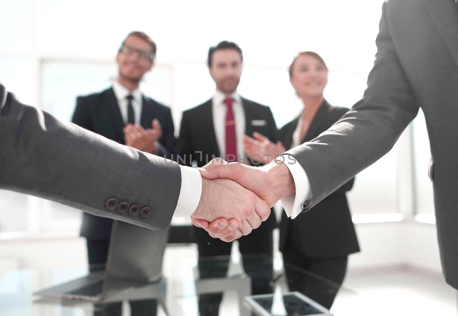 business handshake over blurry background office.concept of partnership