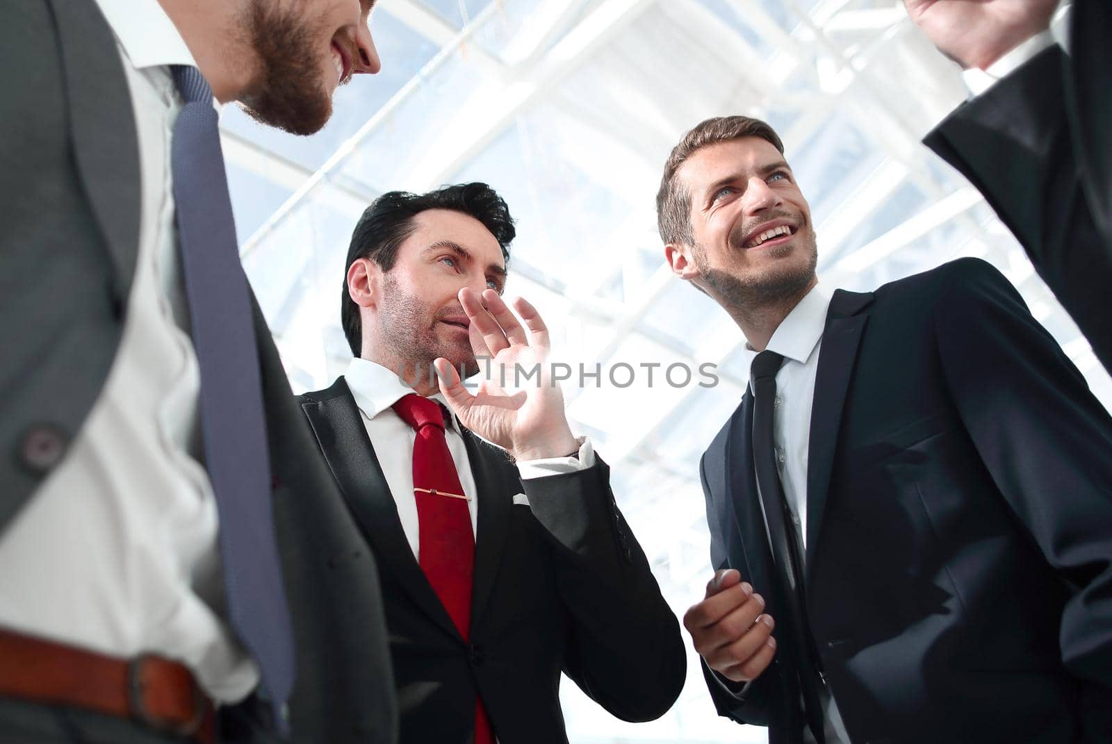 close up.friendly business team standing in the office by asdf