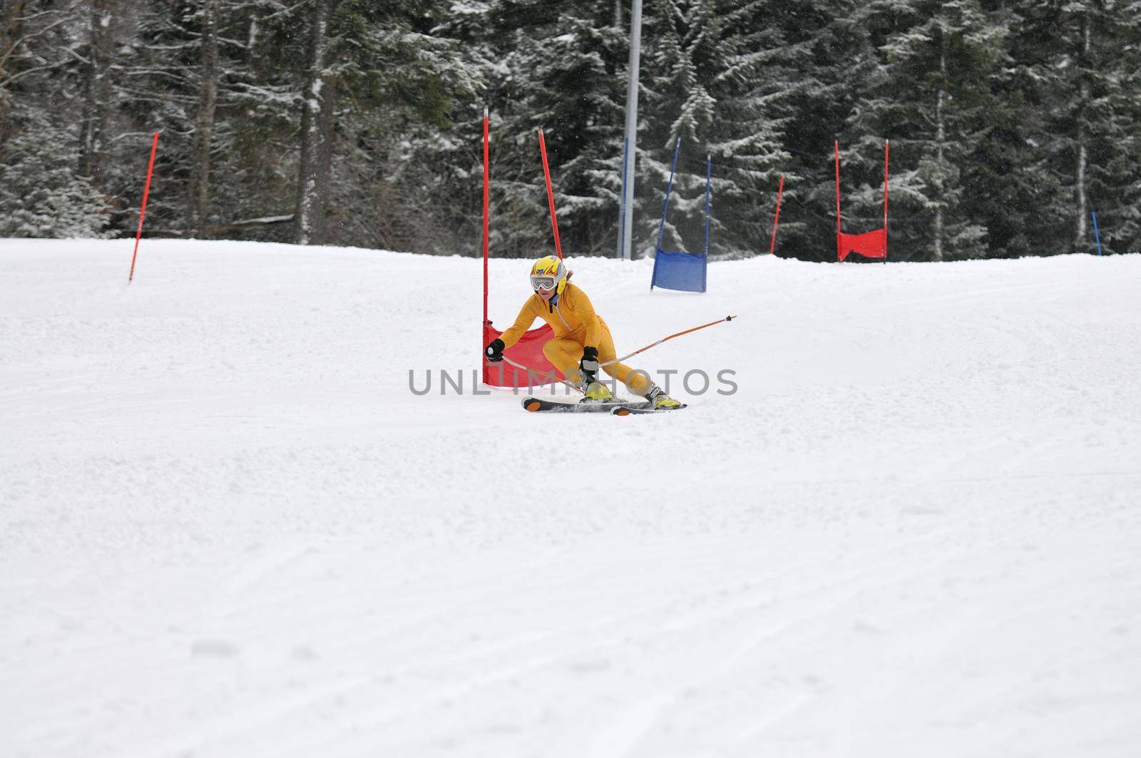young skier race fast downhil at winter snow scene 
