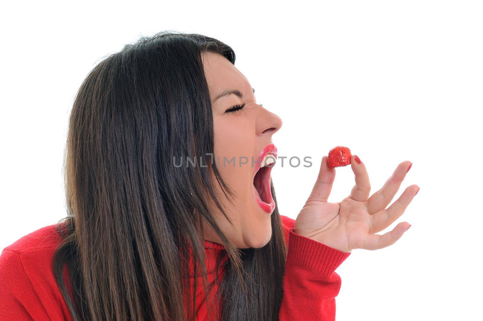 young woman isolated on white in red shirt eat sweet tasty chocolate