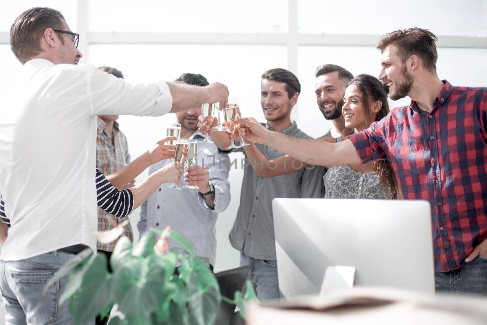 creative business team raising their glasses of champagne.the concept of a startup