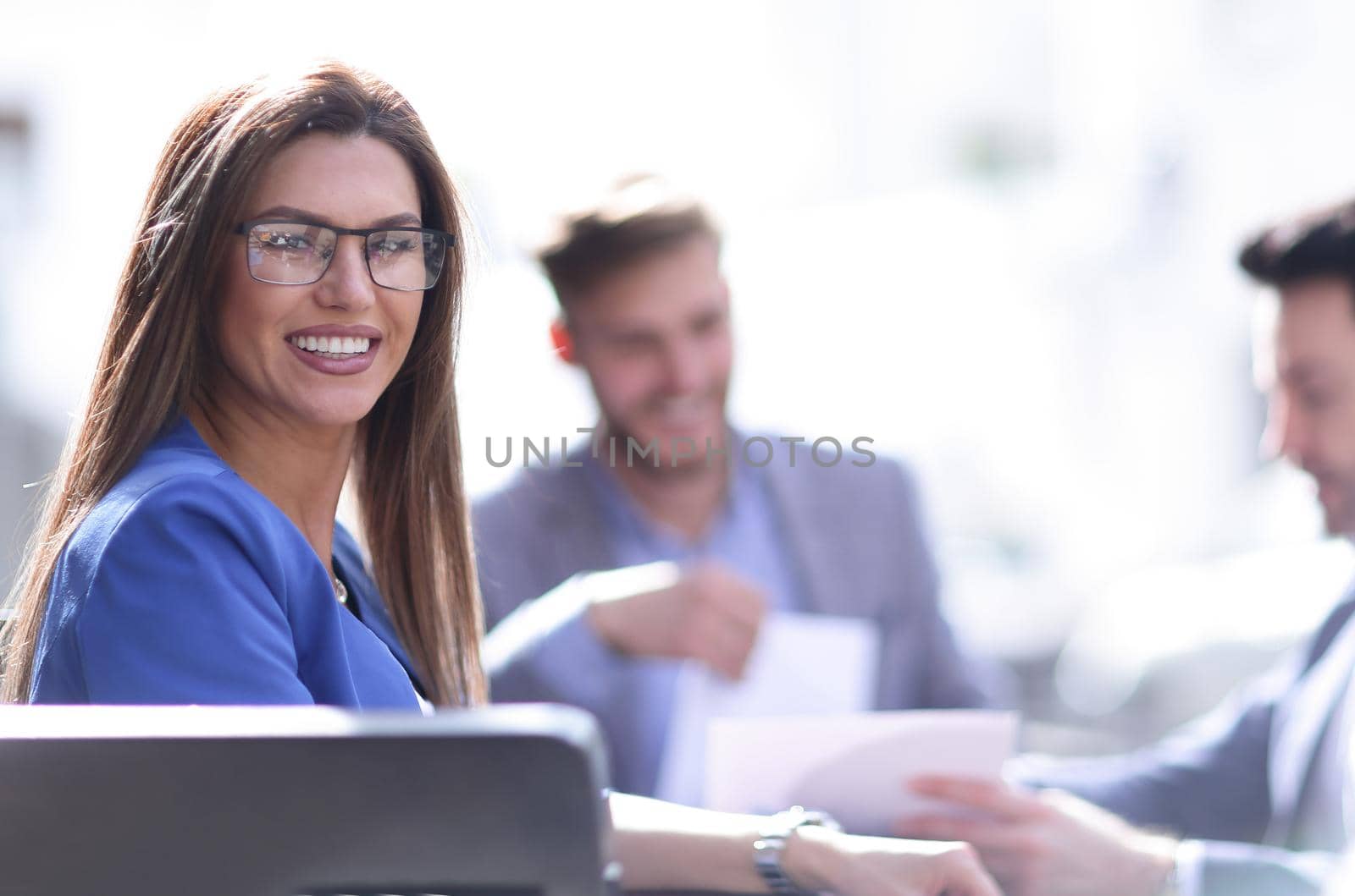 business woman sitting at a table on the background of colleagues.photo with copy space