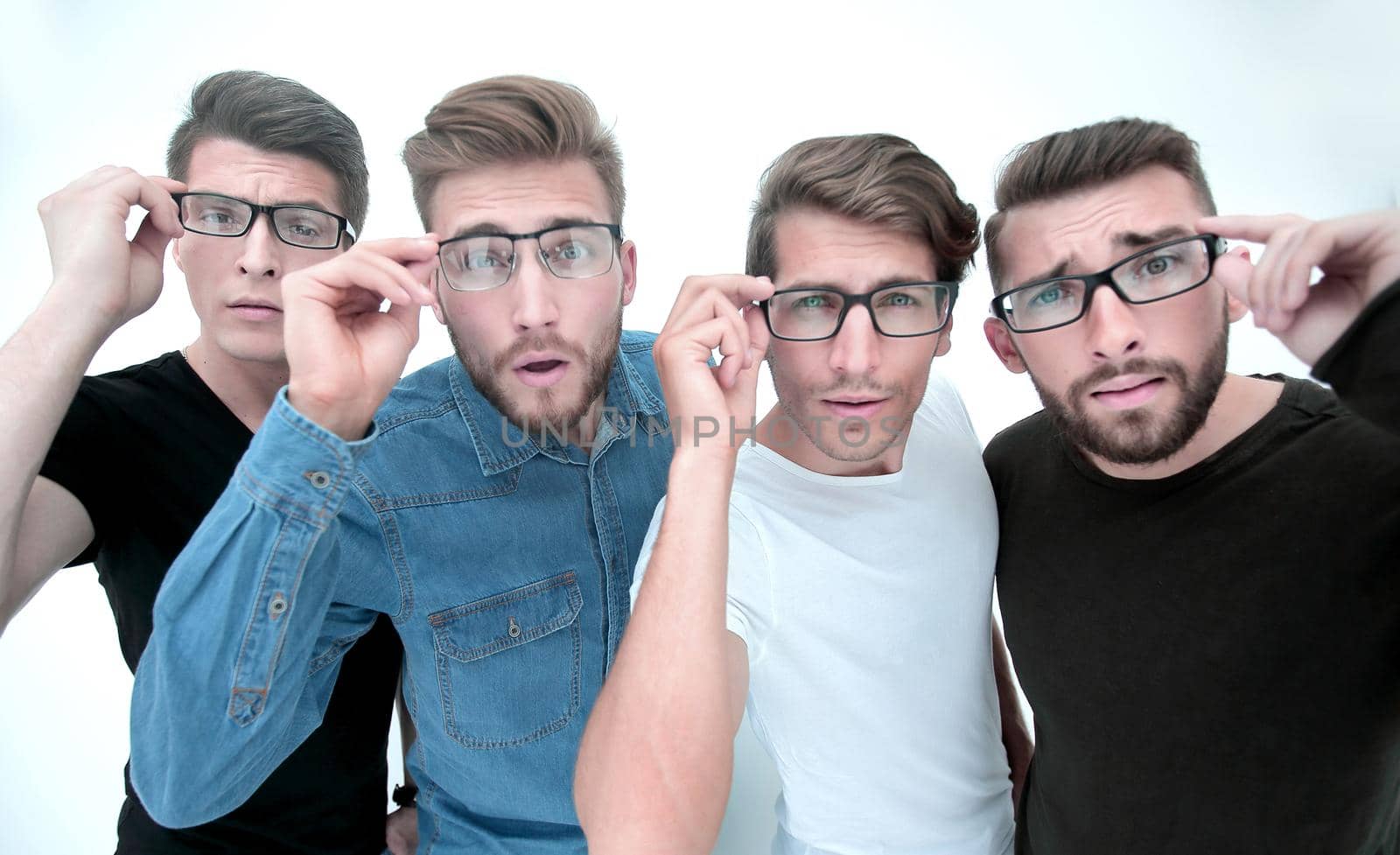 close up. a group of creative young men looking at you through glasses