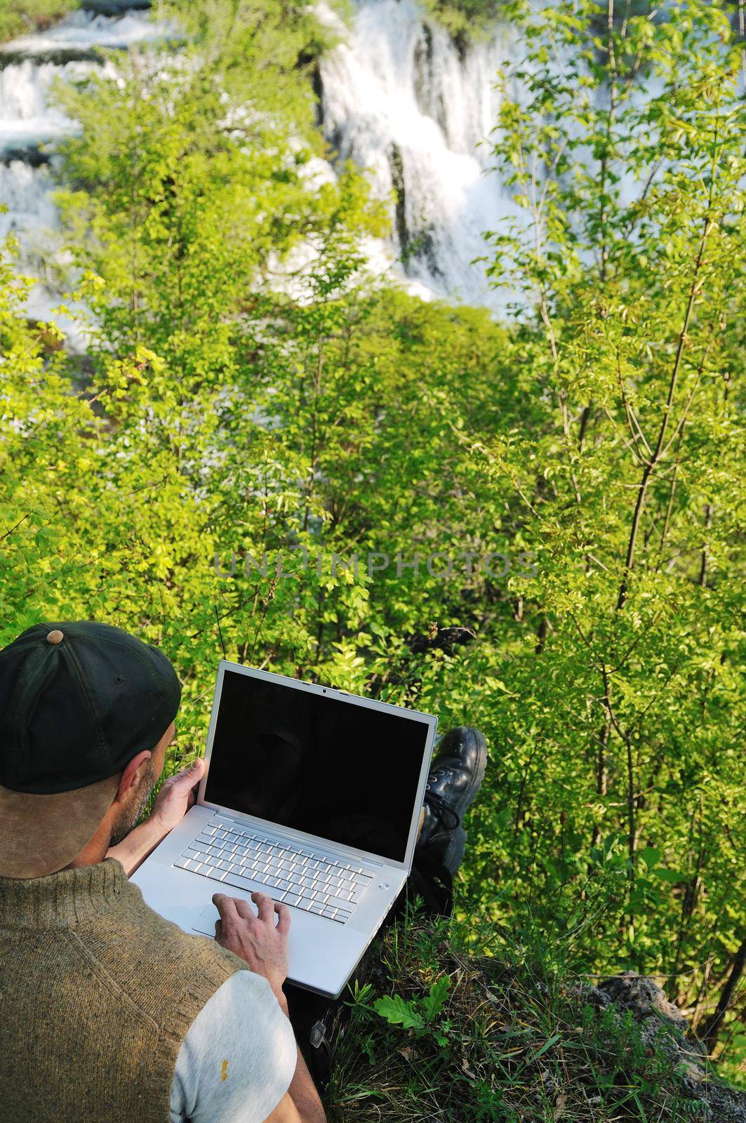 man outdoor laptop by dotshock