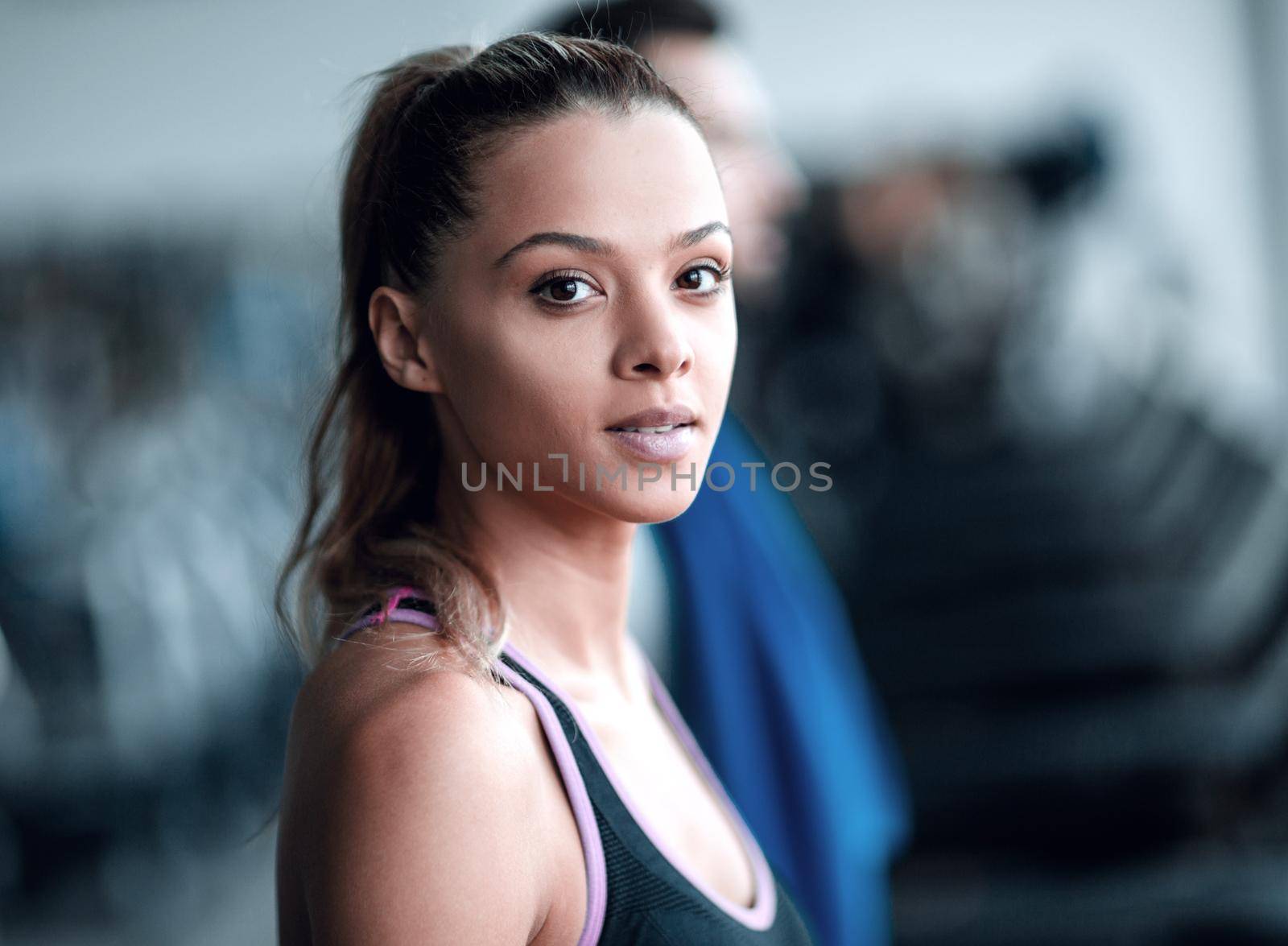 close up. attractive young woman in the gym. by asdf