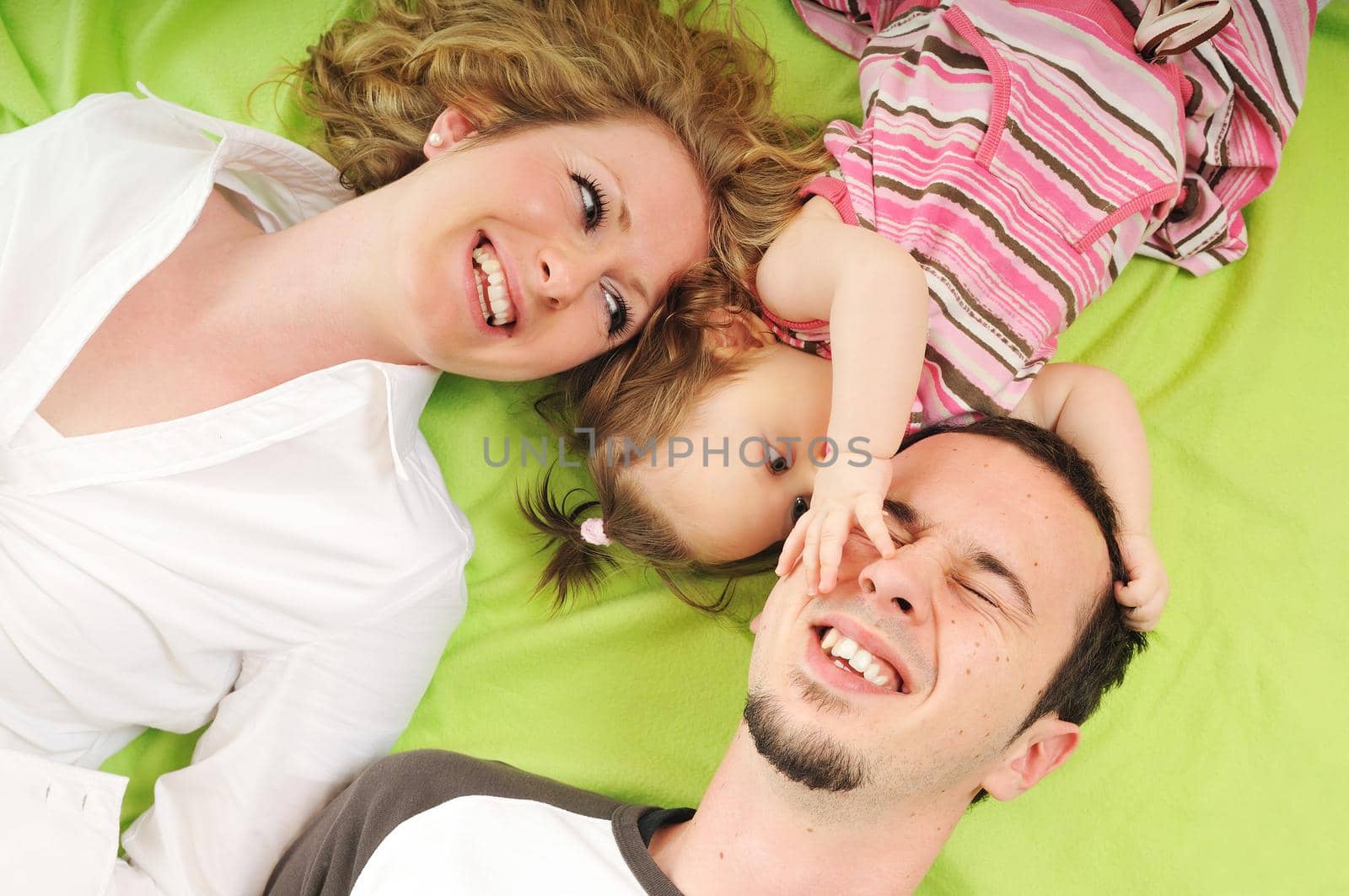 young happy family with beautiful baby playing and smile  isolated on white in studio 