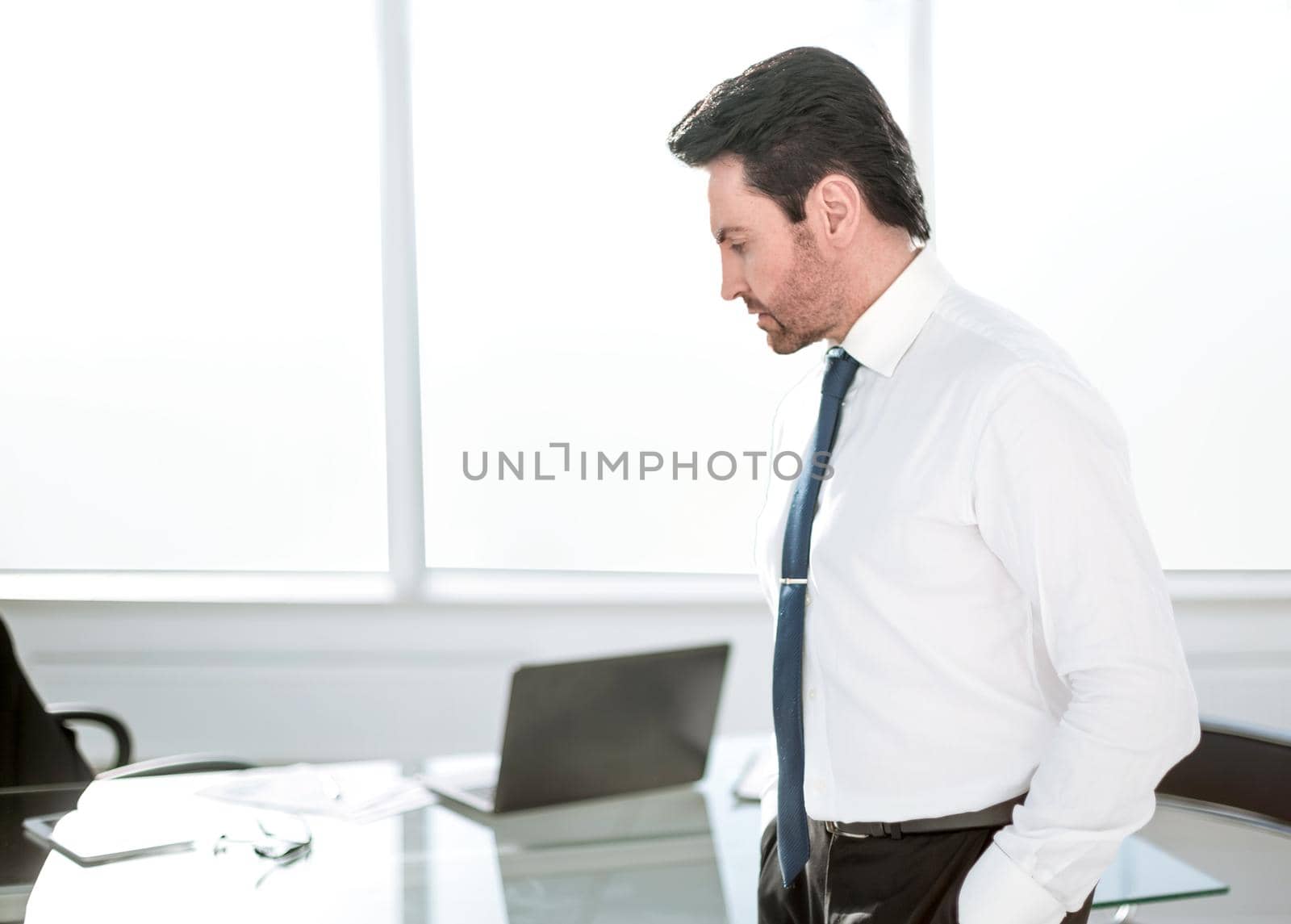 close up.serious businessman standing in the office.photo with copy space