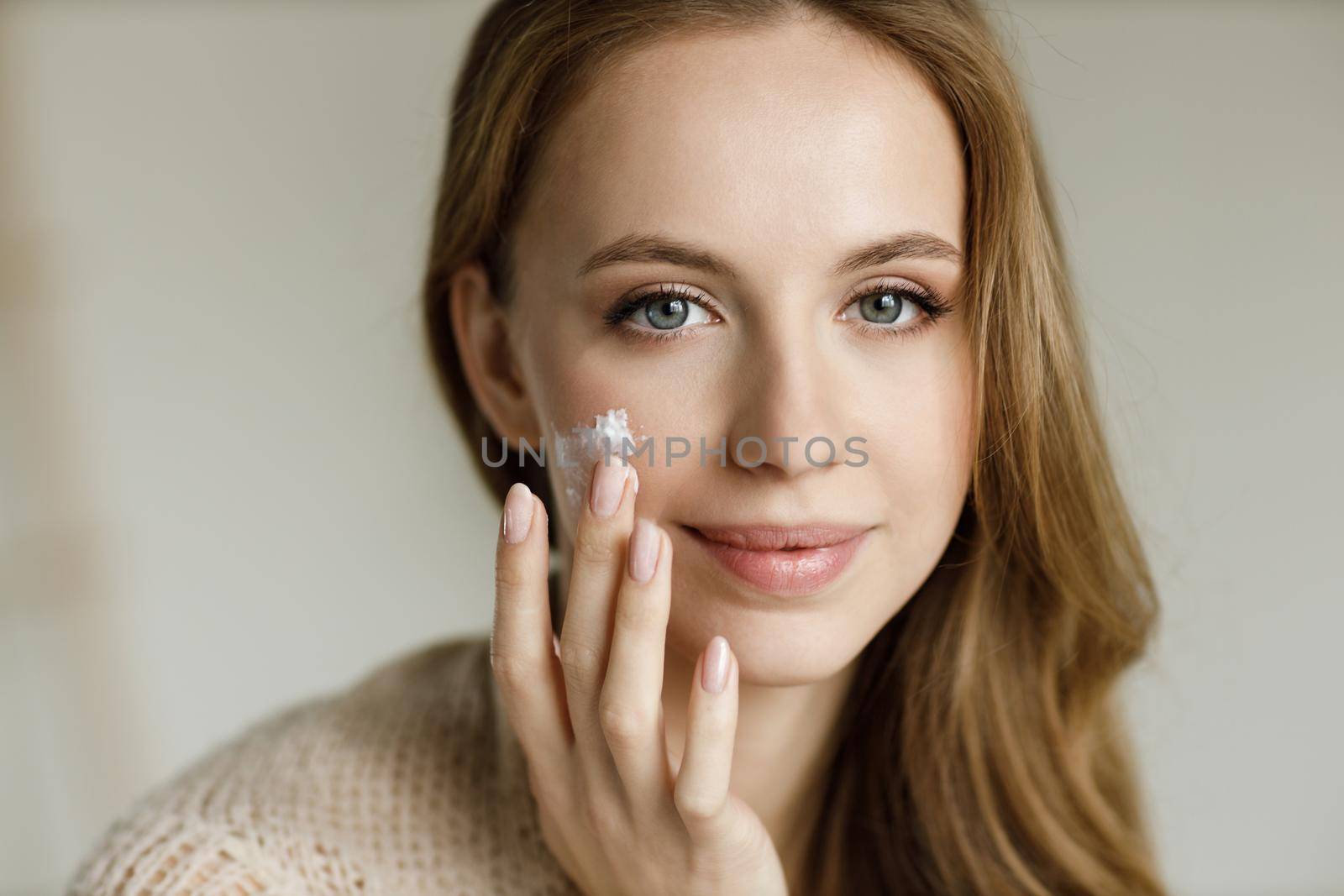 Young happy woman with cream . High quality photo