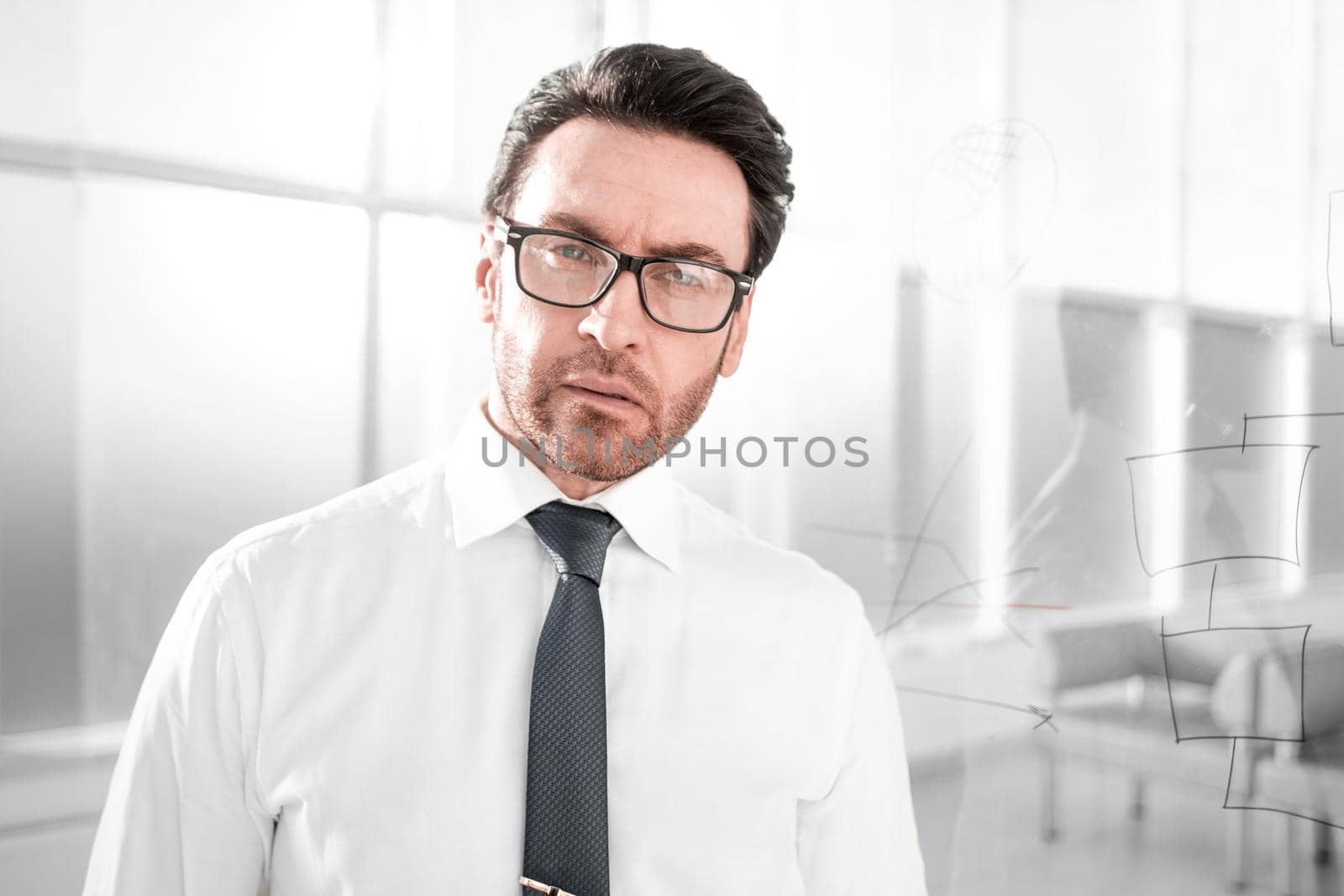 modern businessman standing near a transparent Board.photo with copy space