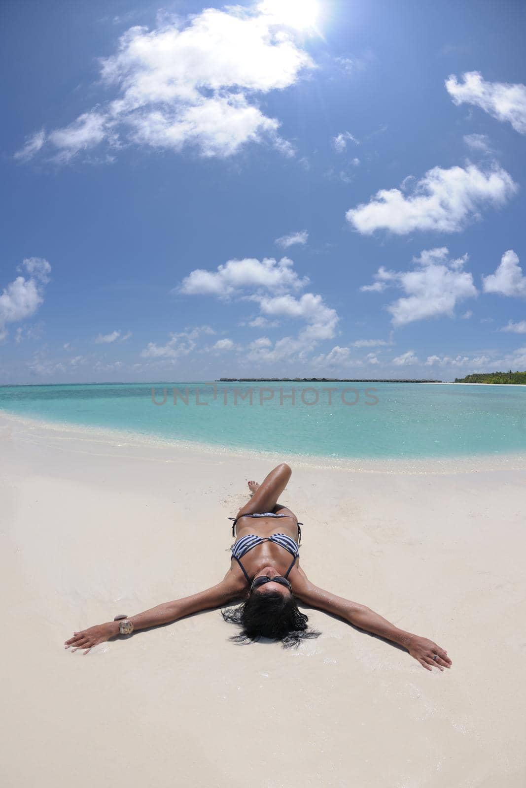 beautiful young woman  on beach have fun and relax by dotshock