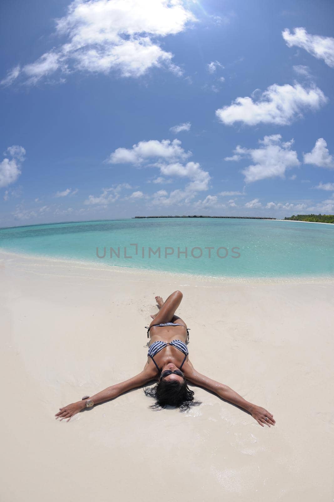 beautiful and happy young woman on beach have fun and relax on summer vacation  over the crystal clear sea