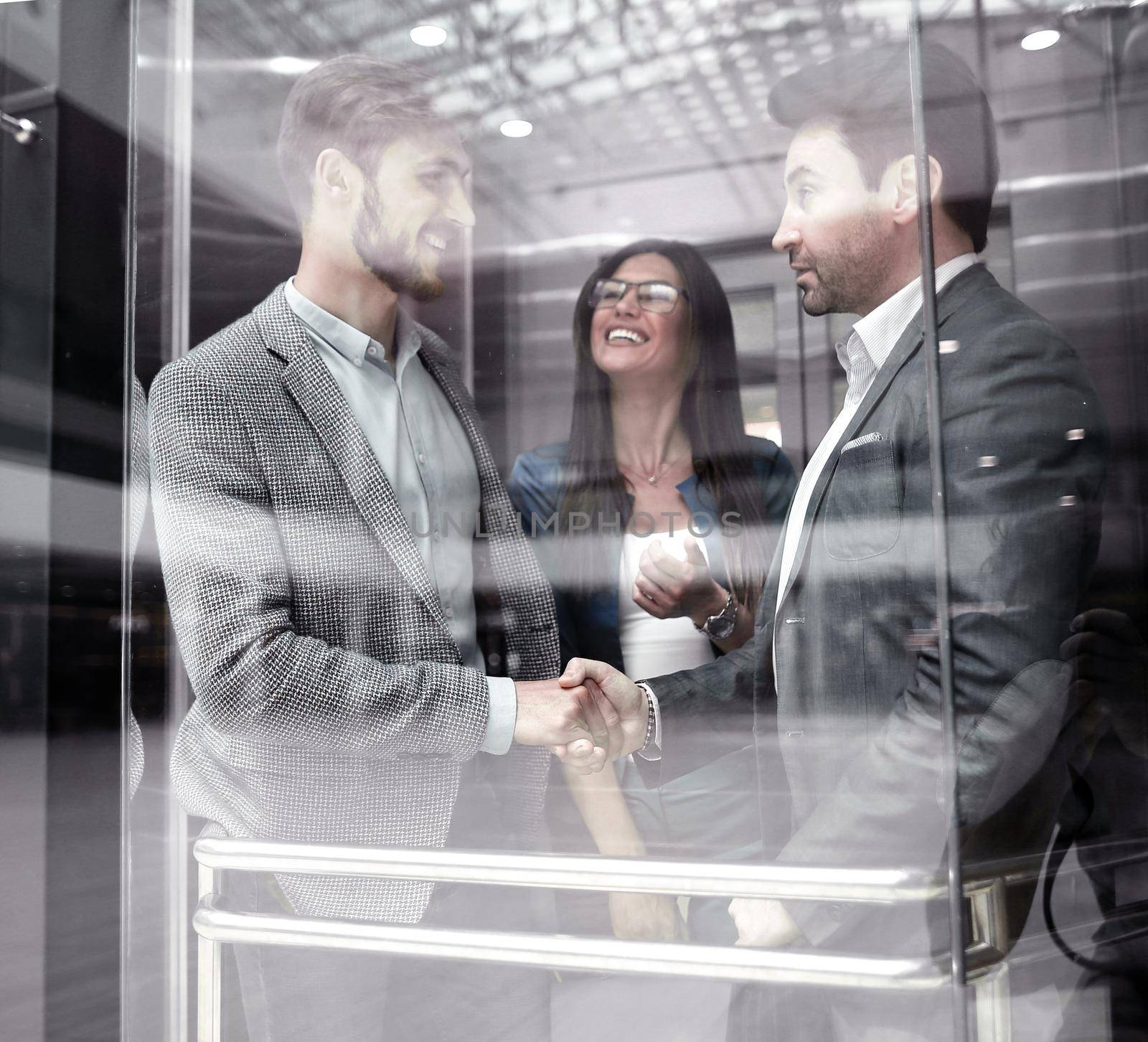 colleagues shaking hands in the Elevator.business concept