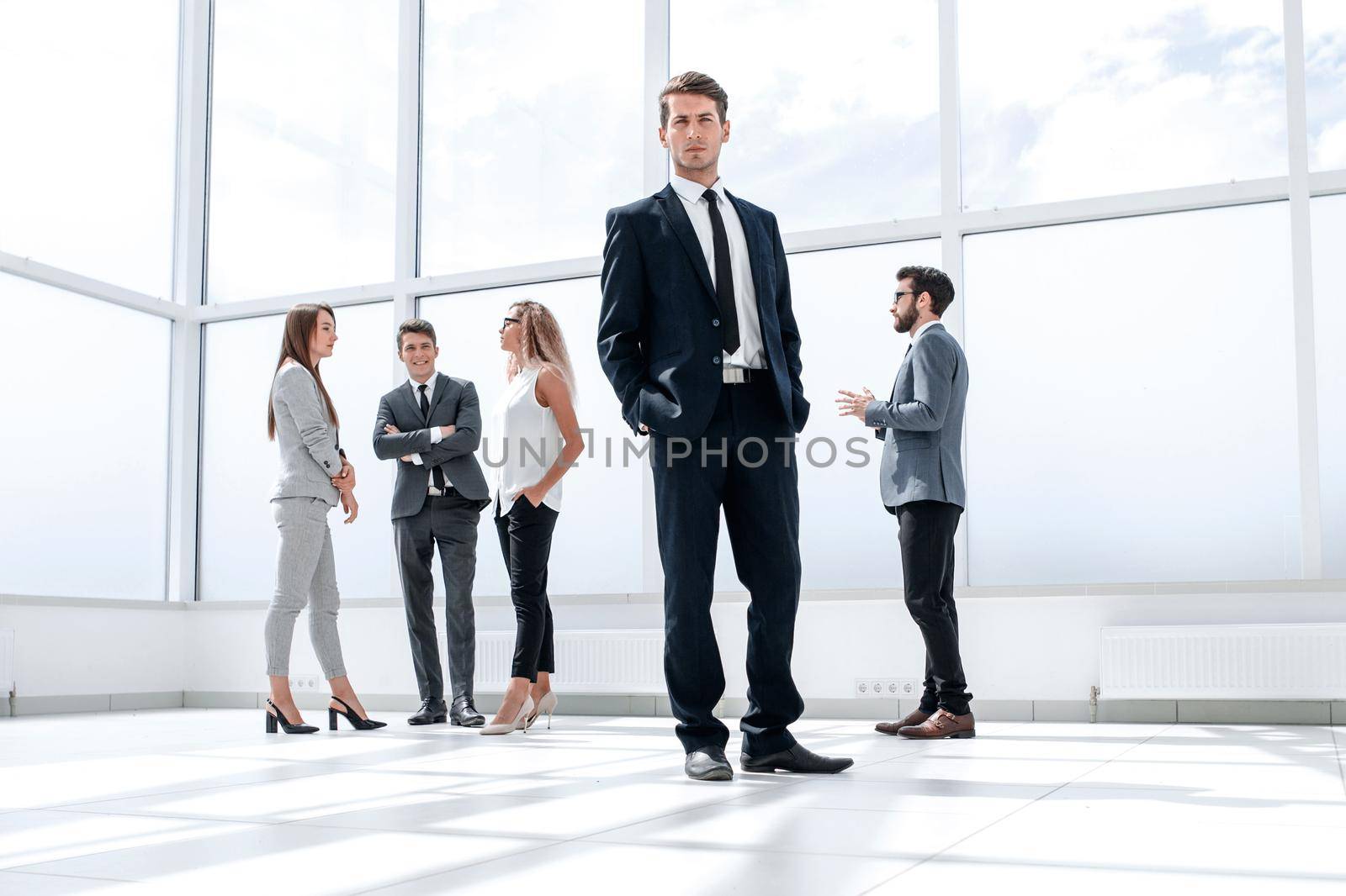 bottom view.confident businessman standing in a spacious hall .business and education