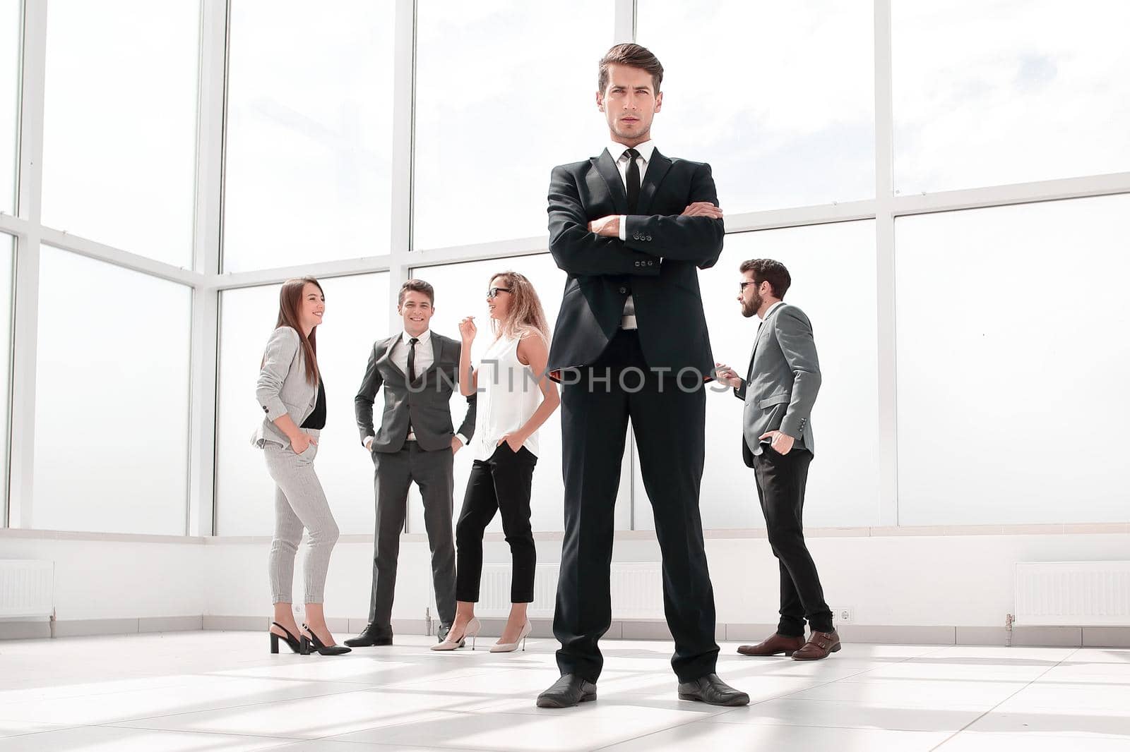 bottom view.confident businessman standing in spacious lobby by asdf