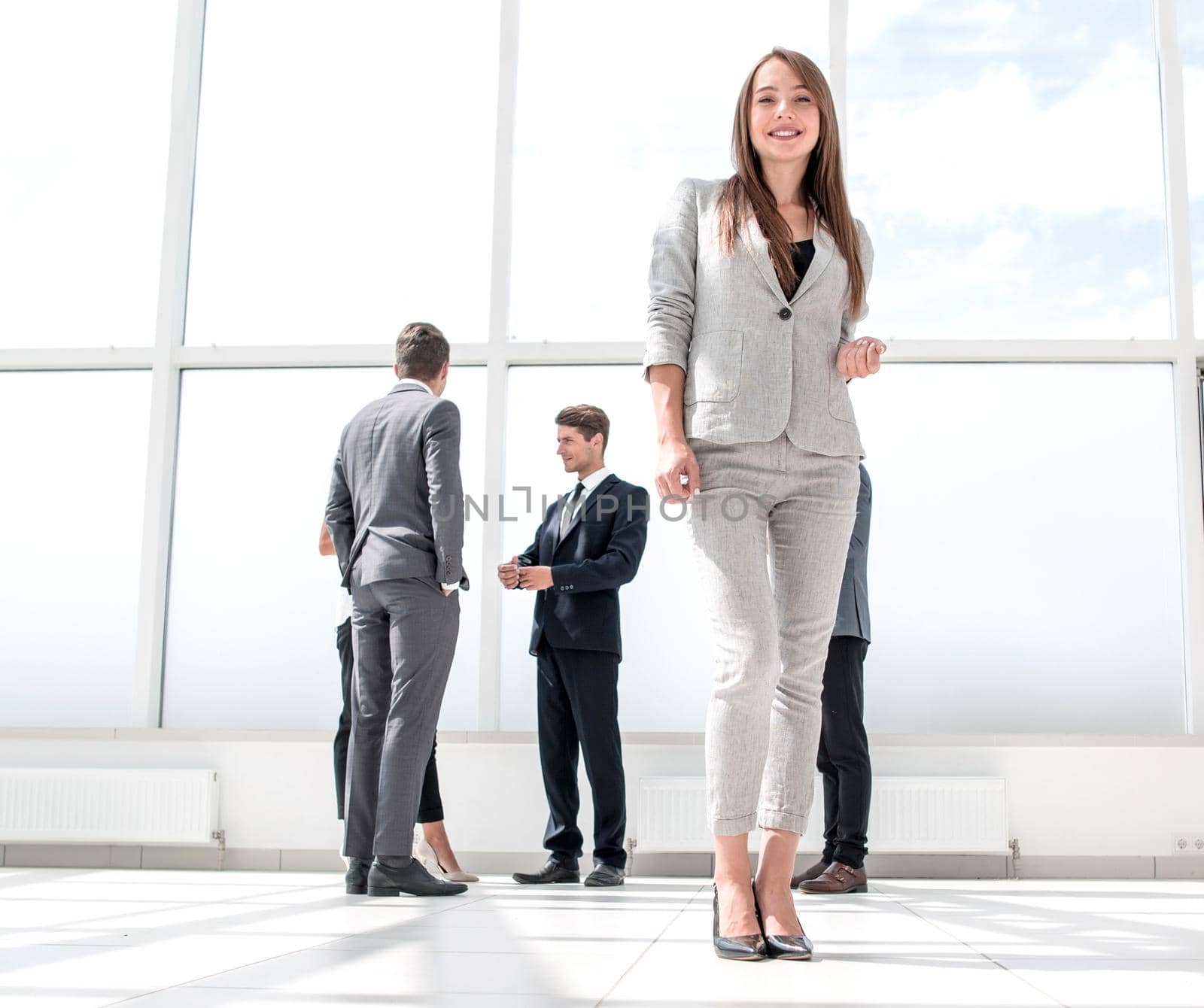 bottom view.young businesswoman standing in a spacious lobby .photo with copy space