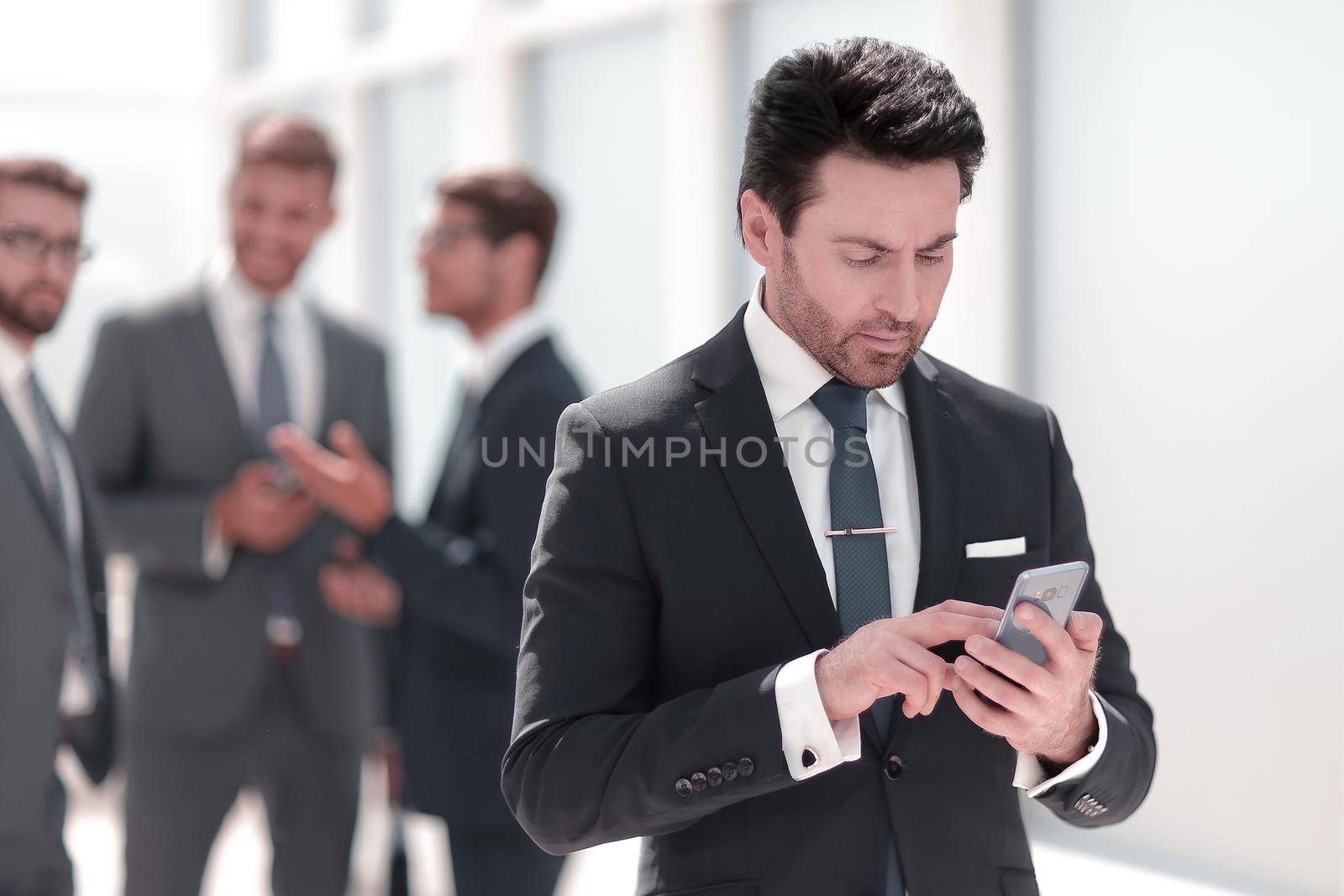 businessman looking at the smartphone screen .people and technology