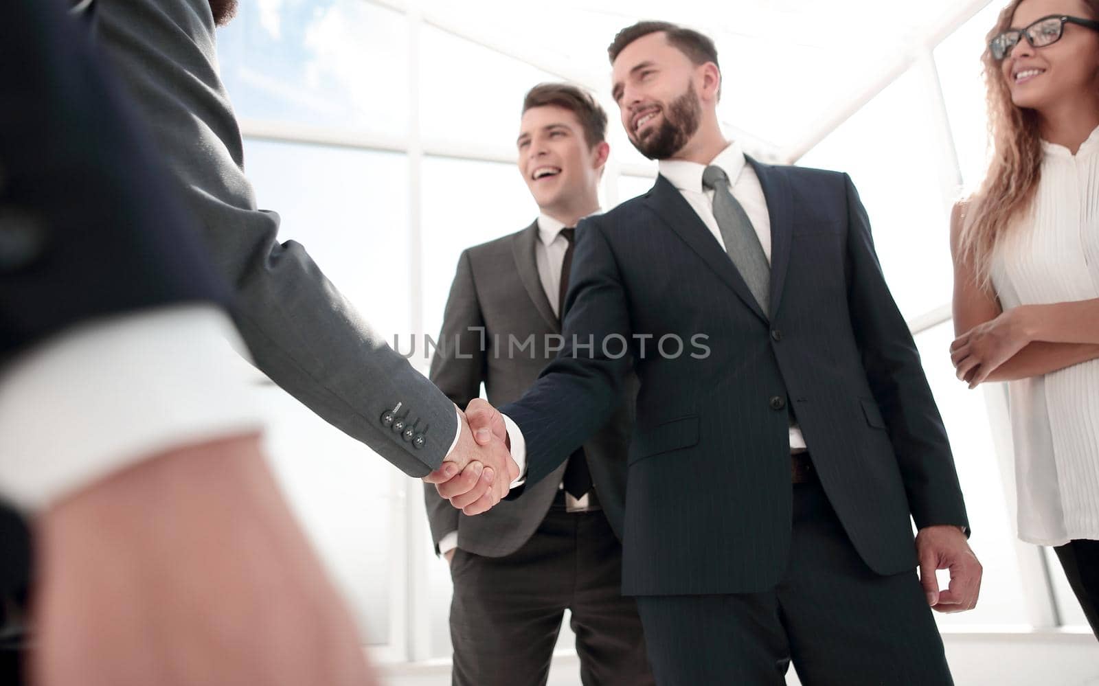 business partners confirming the transaction with their handshake.concept of partnership